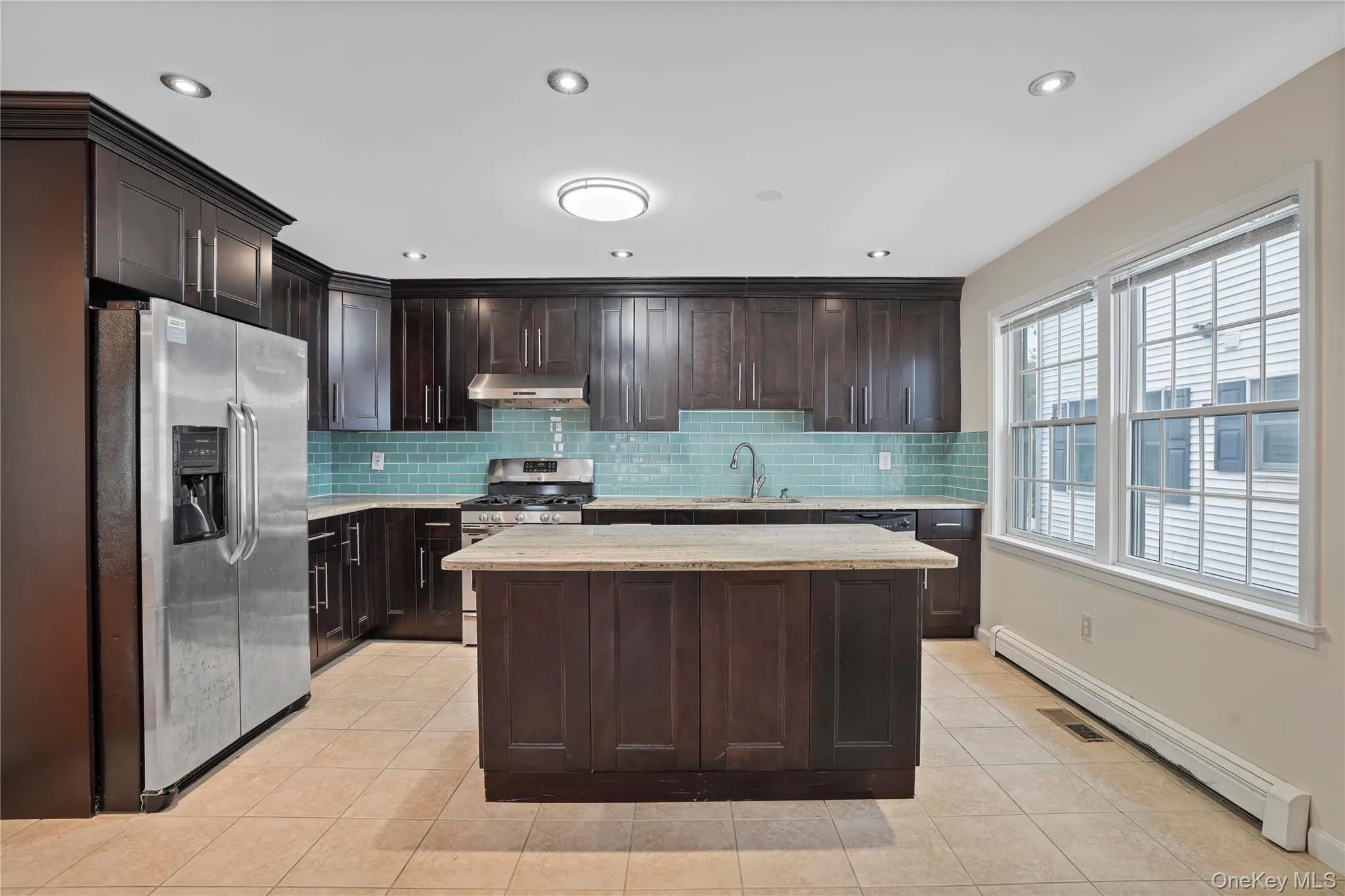 Kitchen with spacious island, stainless steel appliances and ample storage and counter space. Kitchen with spacious island, stainless steel appliances and ample storage and counter space.