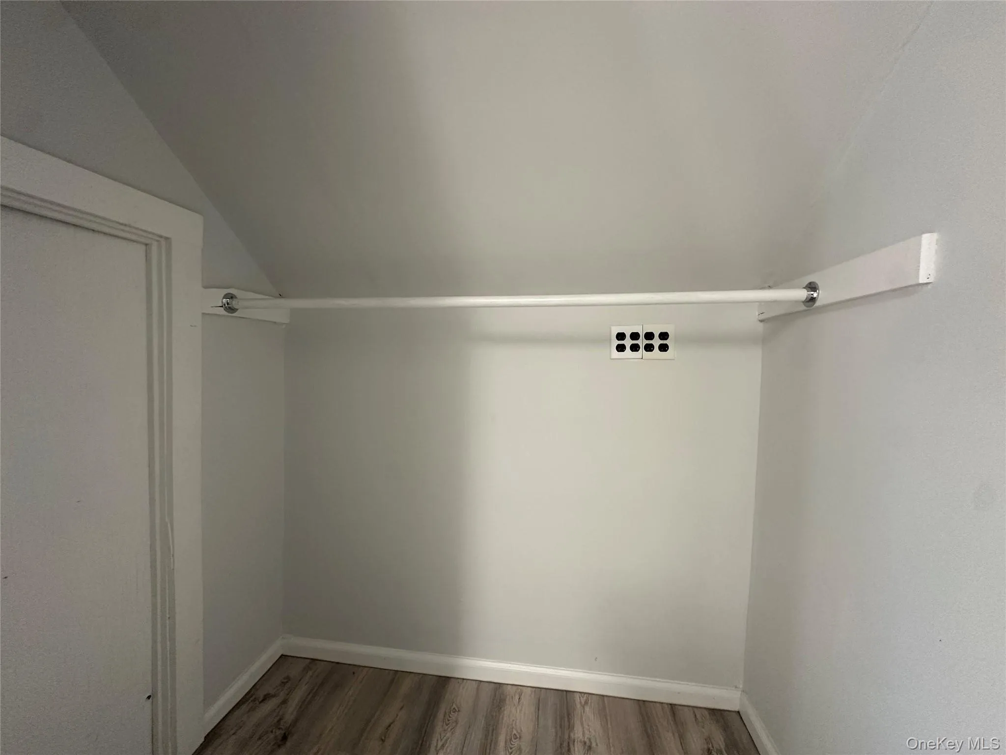 Spacious closet with vaulted ceiling and wood finished floors Spacious closet with vaulted ceiling and wood finished floors