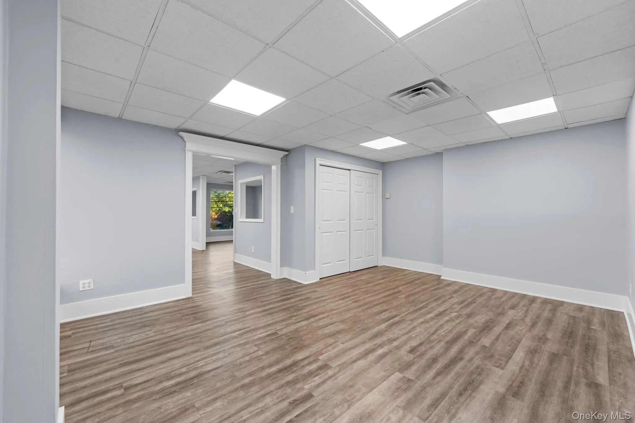 Rear Office with Closet Unfurnished room featuring wood finished floors and a drop ceiling Rear Office with Closet Unfurnished room featuring wood finished floors and a drop ceiling