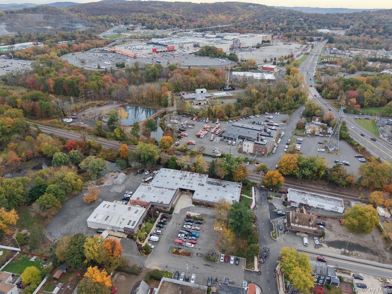 Aerial view of property's location featuring a tree filled landscape Aerial view of property's location featuring a tree filled landscape