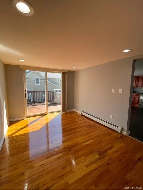 Gleaming hardwood floor, recessed lighting, sliders to deck and baseboard Gleaming hardwood floor, recessed lighting, sliders to deck and baseboard