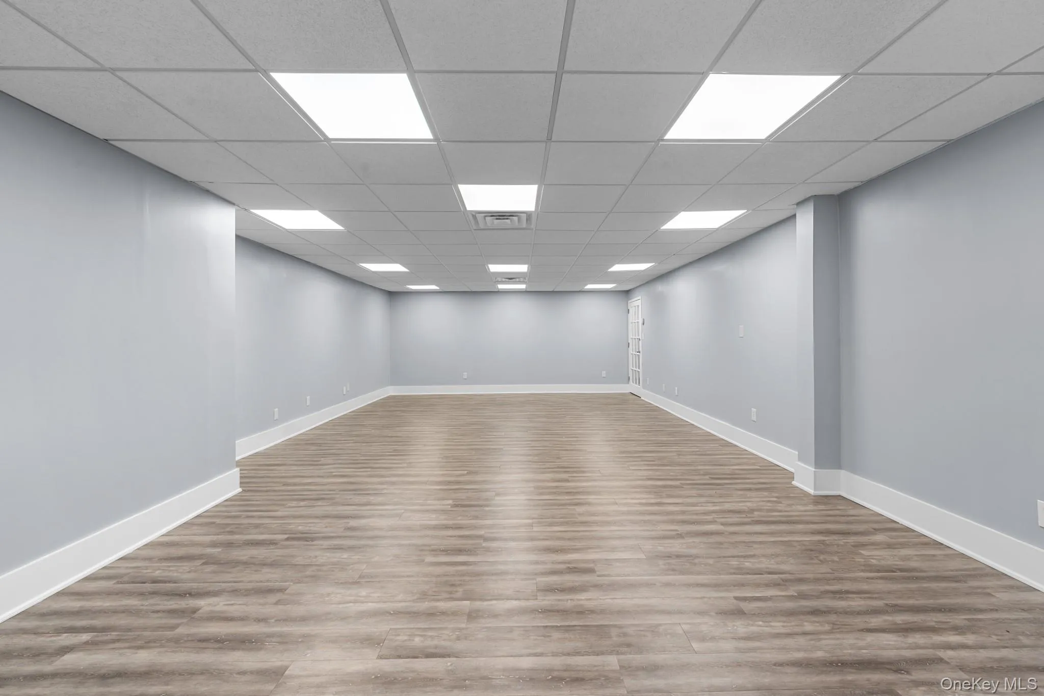 Main featuring light wood-style flooring and a paneled ceiling Main featuring light wood-style flooring and a paneled ceiling