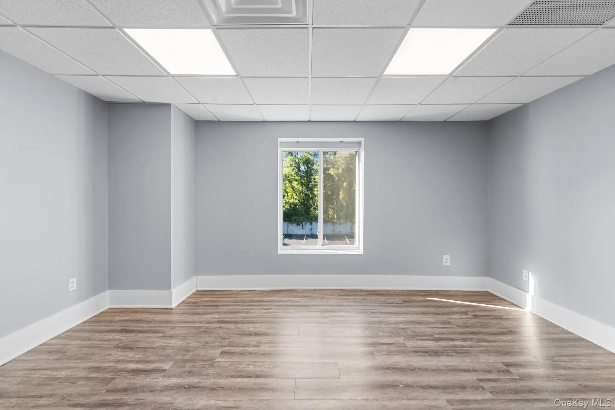 Private office room with a drop ceiling and light wood finished floors Private office room with a drop ceiling and light wood finished floors