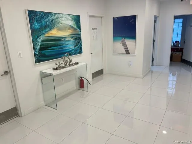 Hallway featuring light tile patterned floors Hallway featuring light tile patterned floors