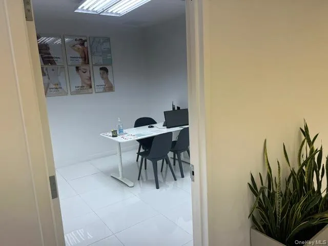 Office with light tile patterned floors and baseboards Office with light tile patterned floors and baseboards