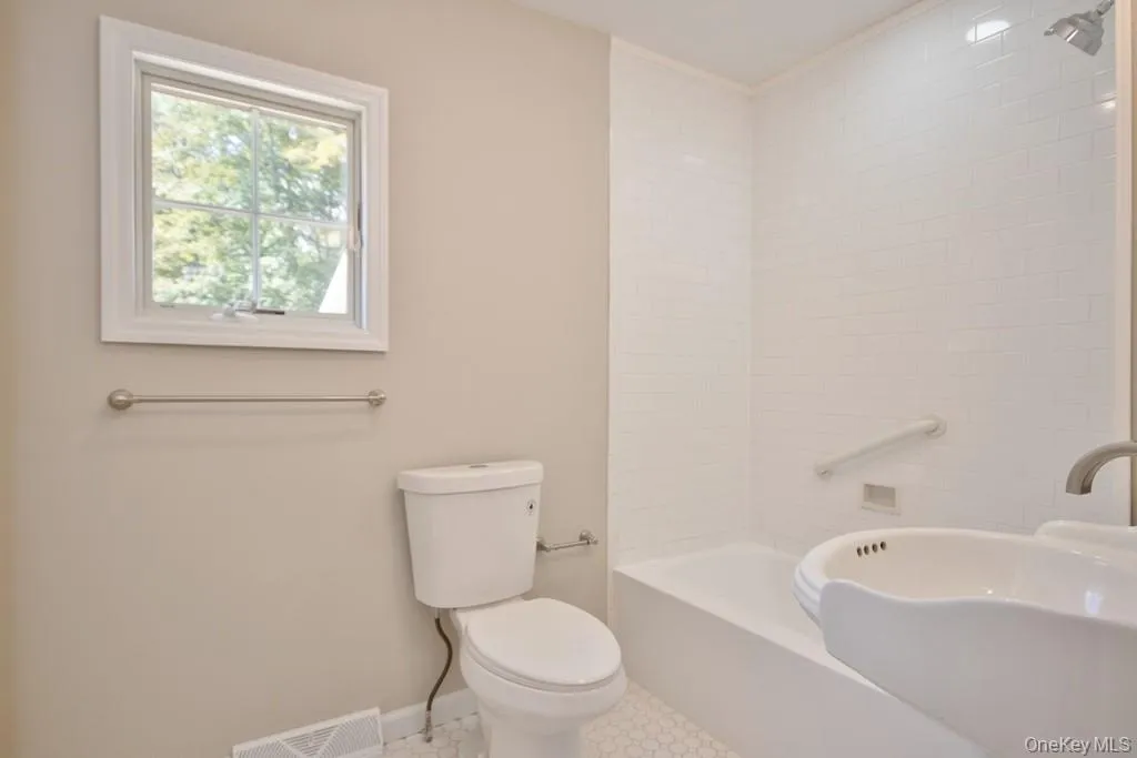 Full bathroom with shower / bath combination and tile patterned floors Full bathroom with shower / bath combination and tile patterned floors