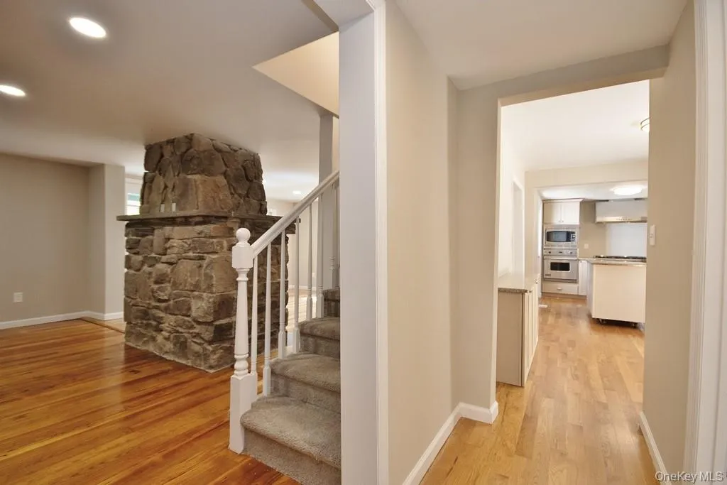 Staircase featuring wood finished floors and recessed lighting Staircase featuring wood finished floors and recessed lighting
