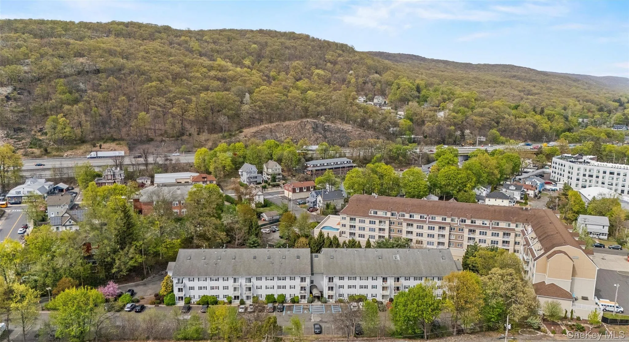 Aerial view with a mountain view and a view of trees Aerial view with a mountain view and a view of trees