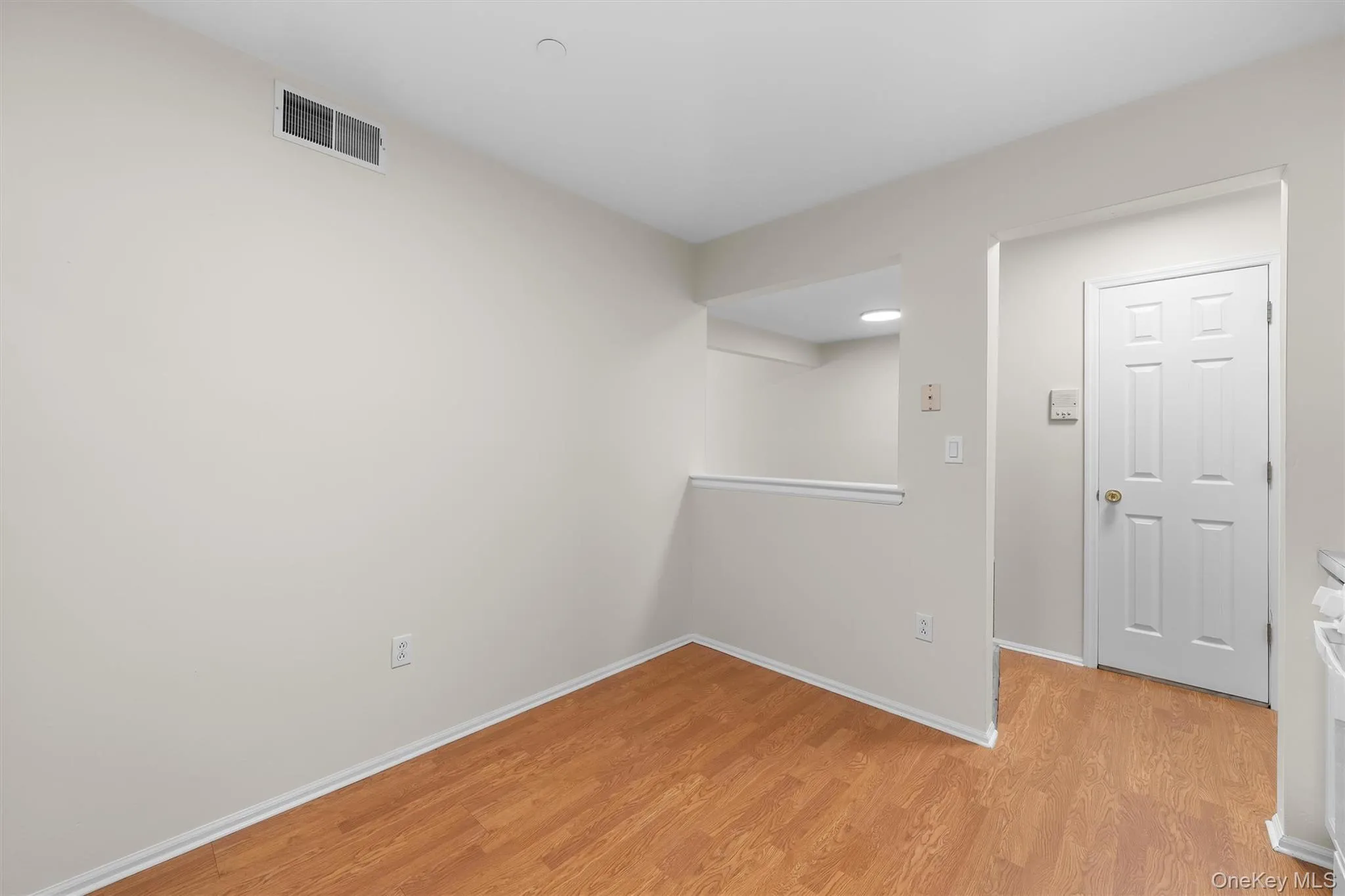 Unfurnished room with visible vents, light wood-type flooring, and baseboards Unfurnished room with visible vents, light wood-type flooring, and baseboards