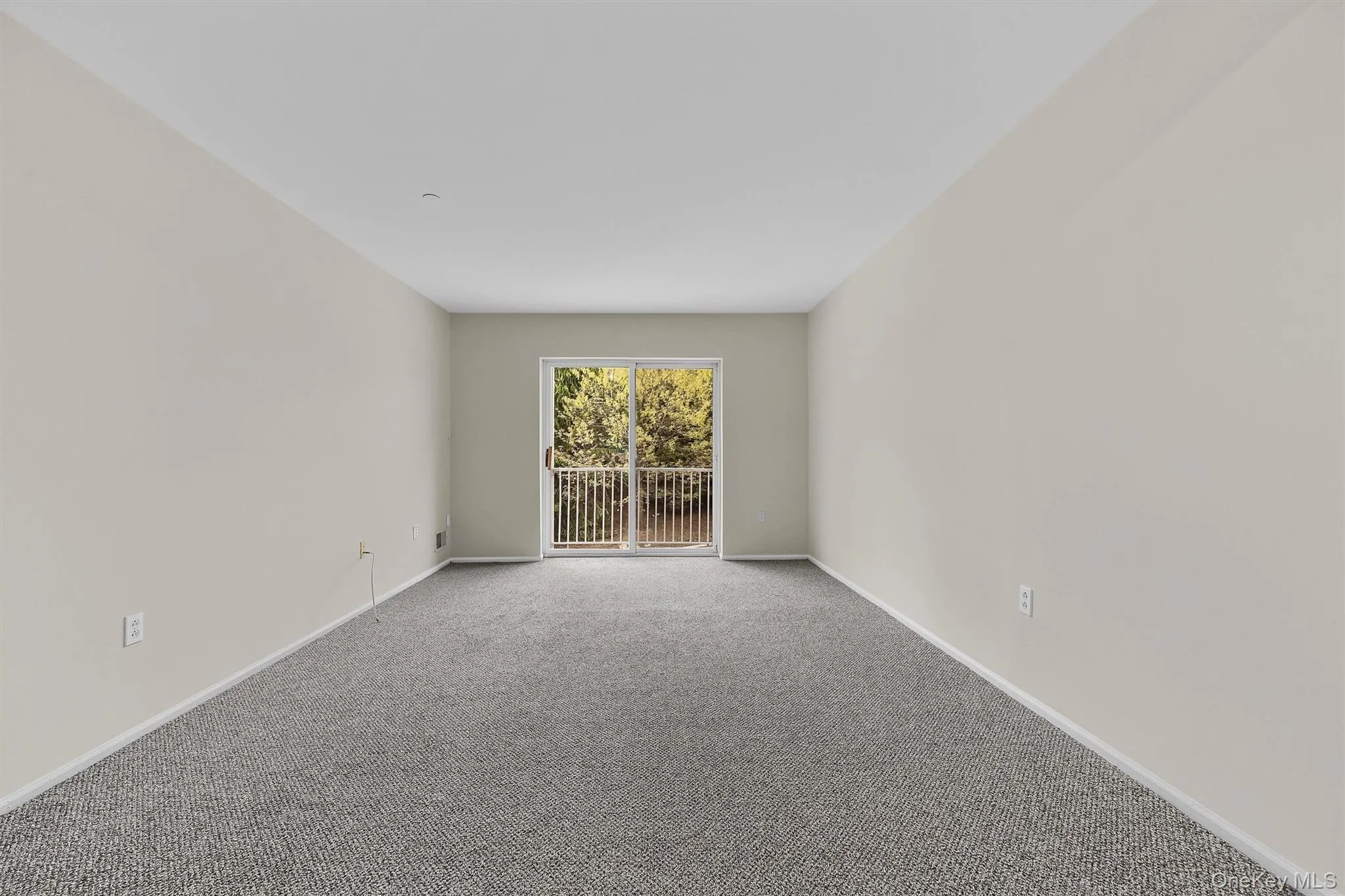 Unfurnished room featuring baseboards and carpet flooring Unfurnished room featuring baseboards and carpet flooring