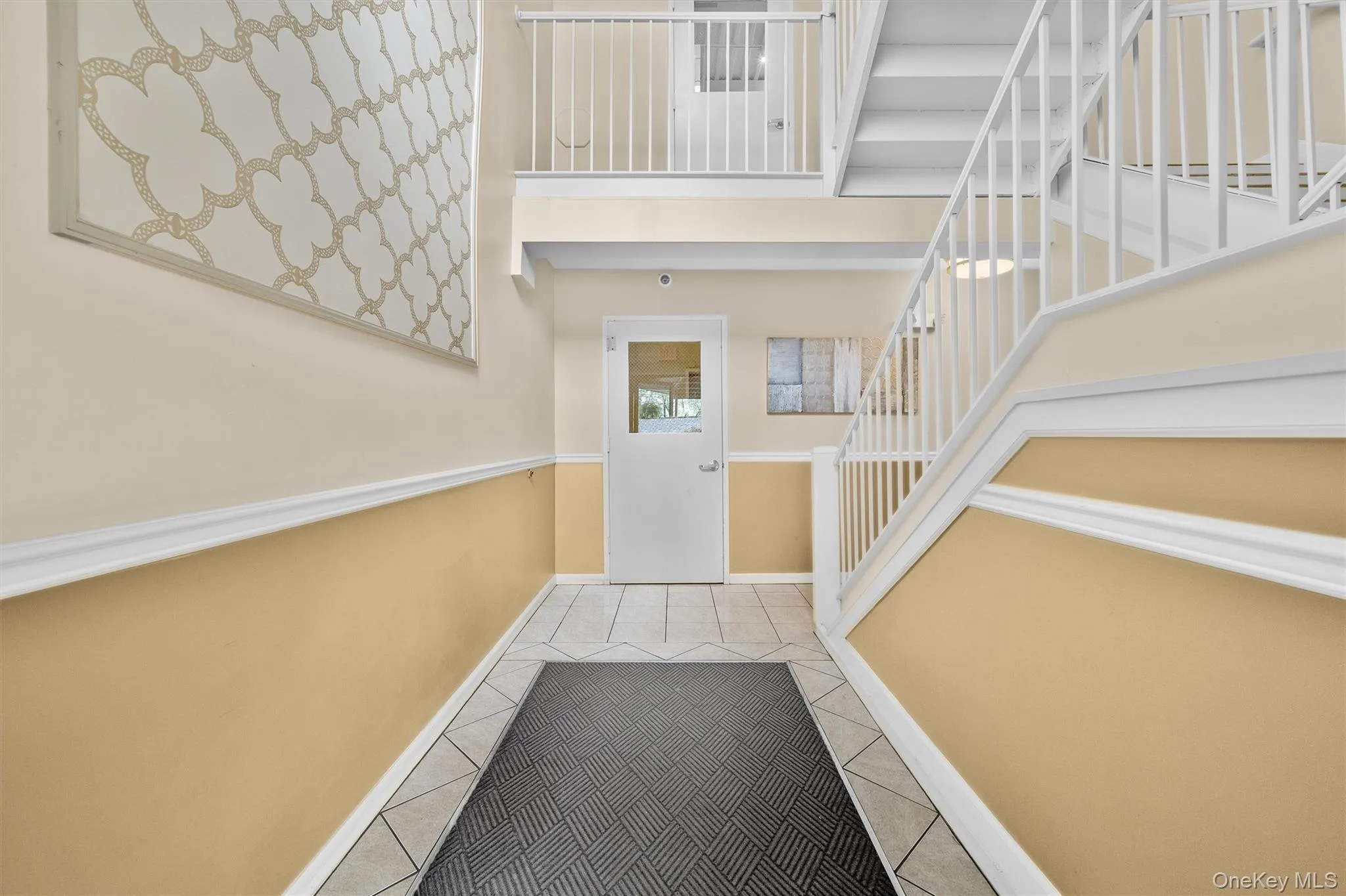Doorway to outside featuring tile patterned floors, baseboards, and stairs Doorway to outside featuring tile patterned floors, baseboards, and stairs