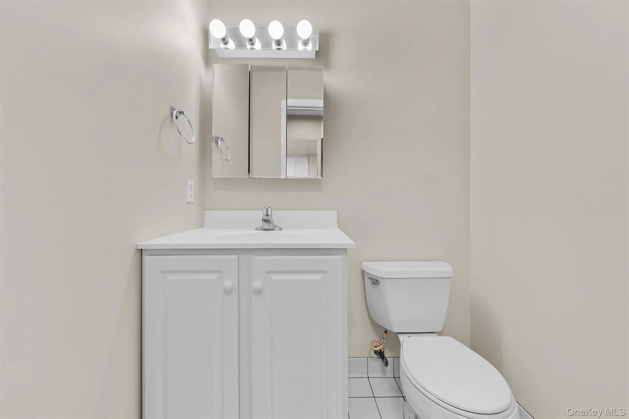 Bathroom with toilet, tile patterned flooring, and vanity Bathroom with toilet, tile patterned flooring, and vanity