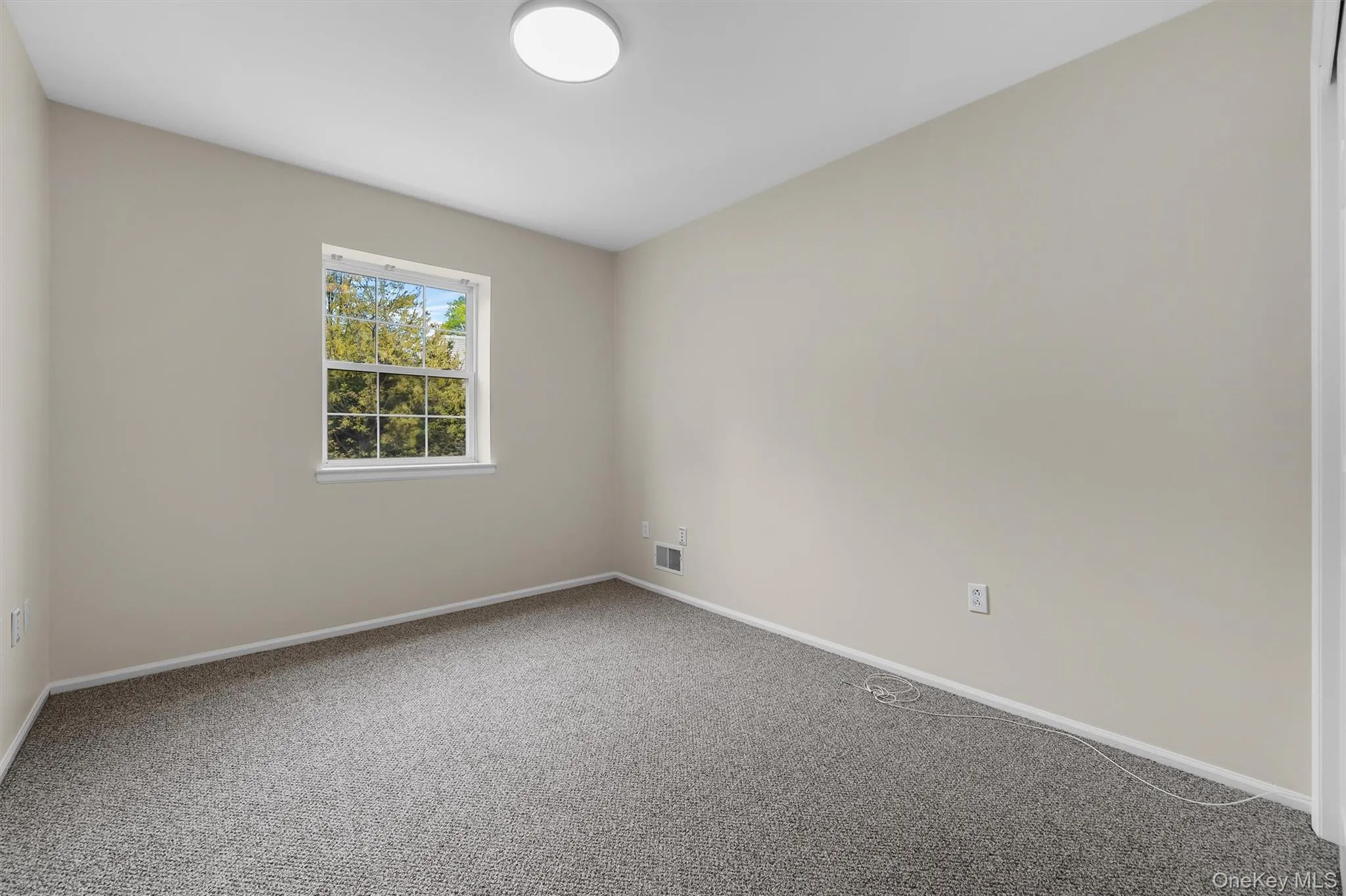 Spare room with baseboards, visible vents, and carpet flooring Spare room with baseboards, visible vents, and carpet flooring