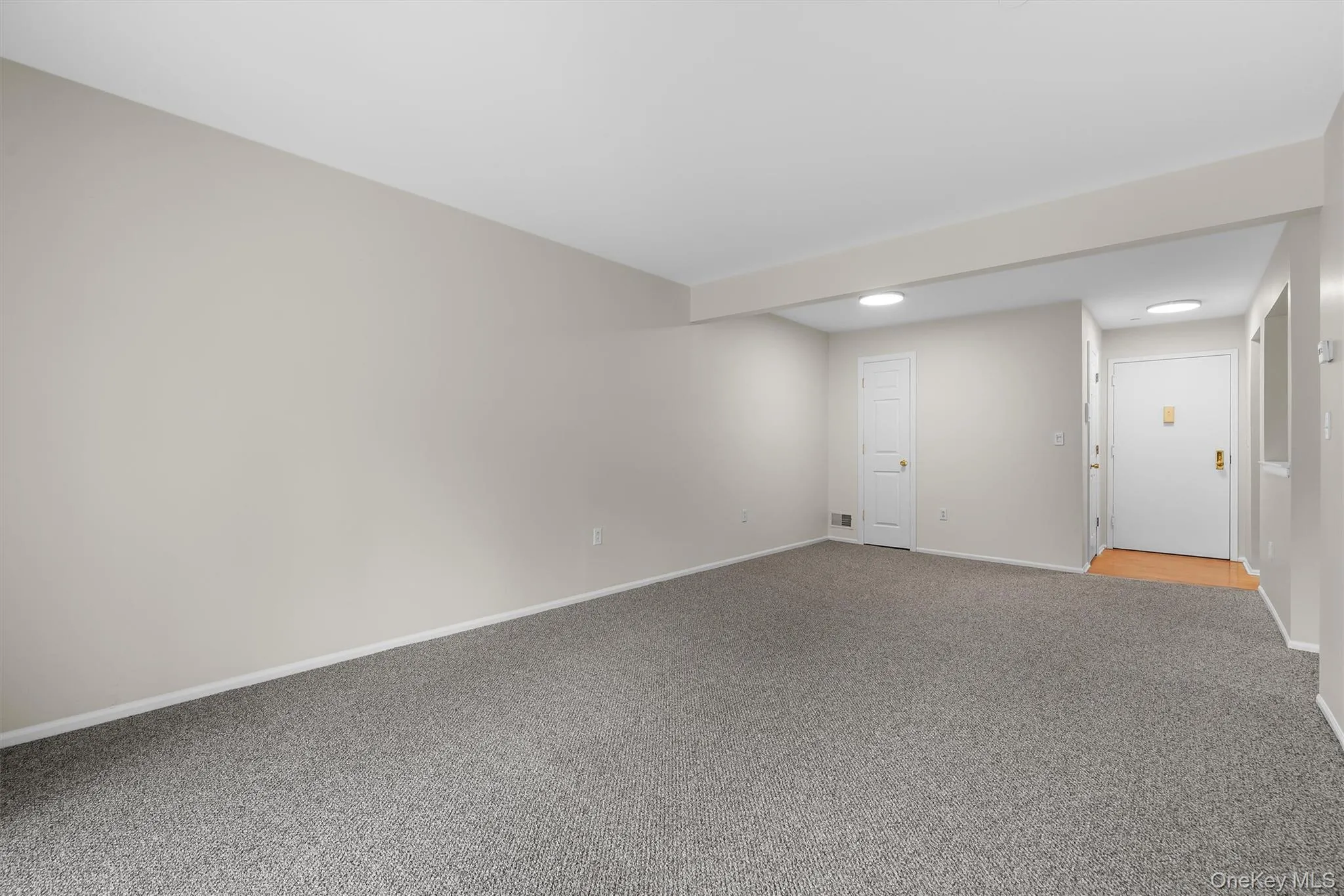 Carpeted empty room with baseboards and recessed lighting Carpeted empty room with baseboards and recessed lighting