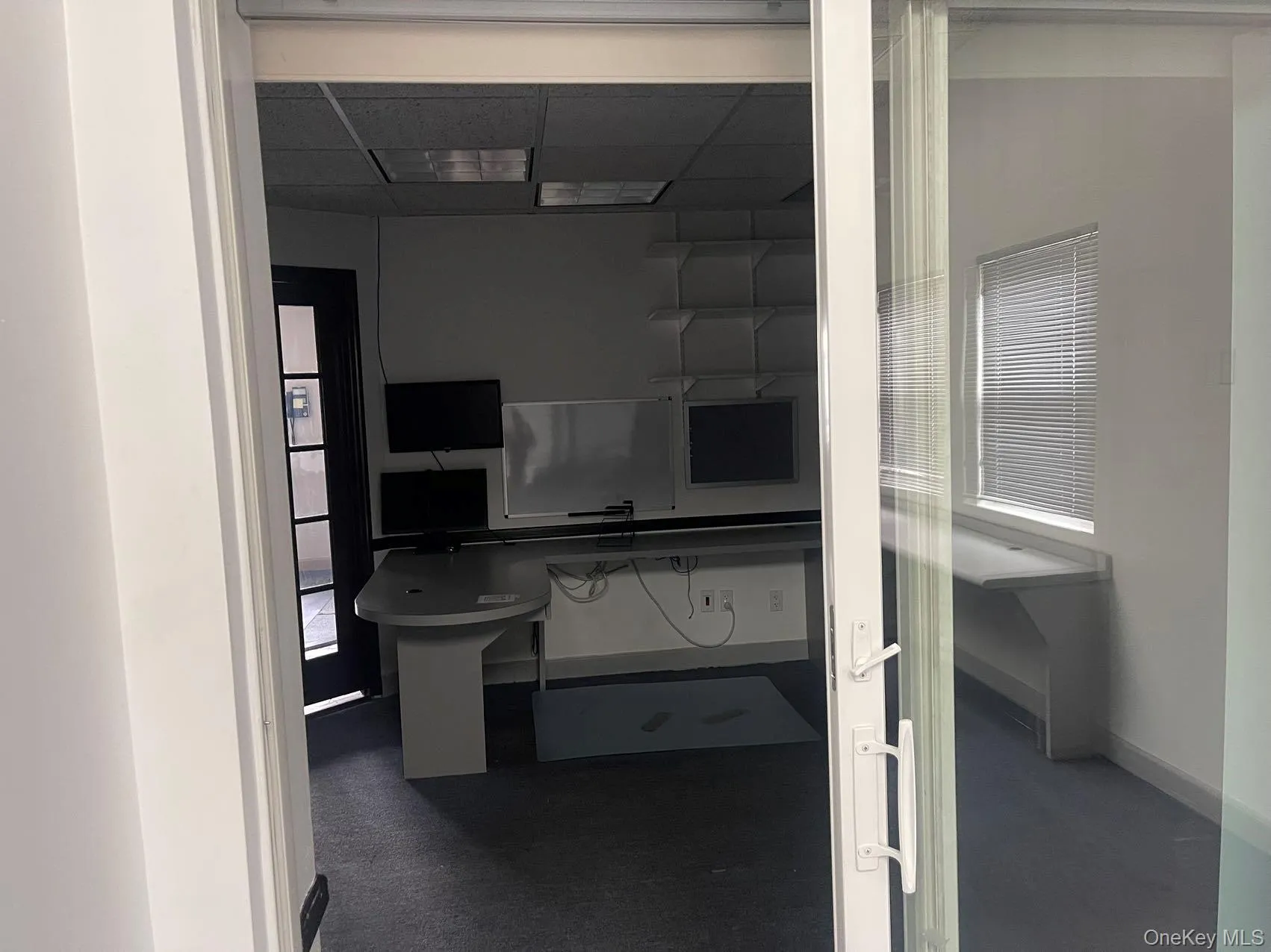 Hall featuring a desk and a paneled ceiling Hall featuring a desk and a paneled ceiling