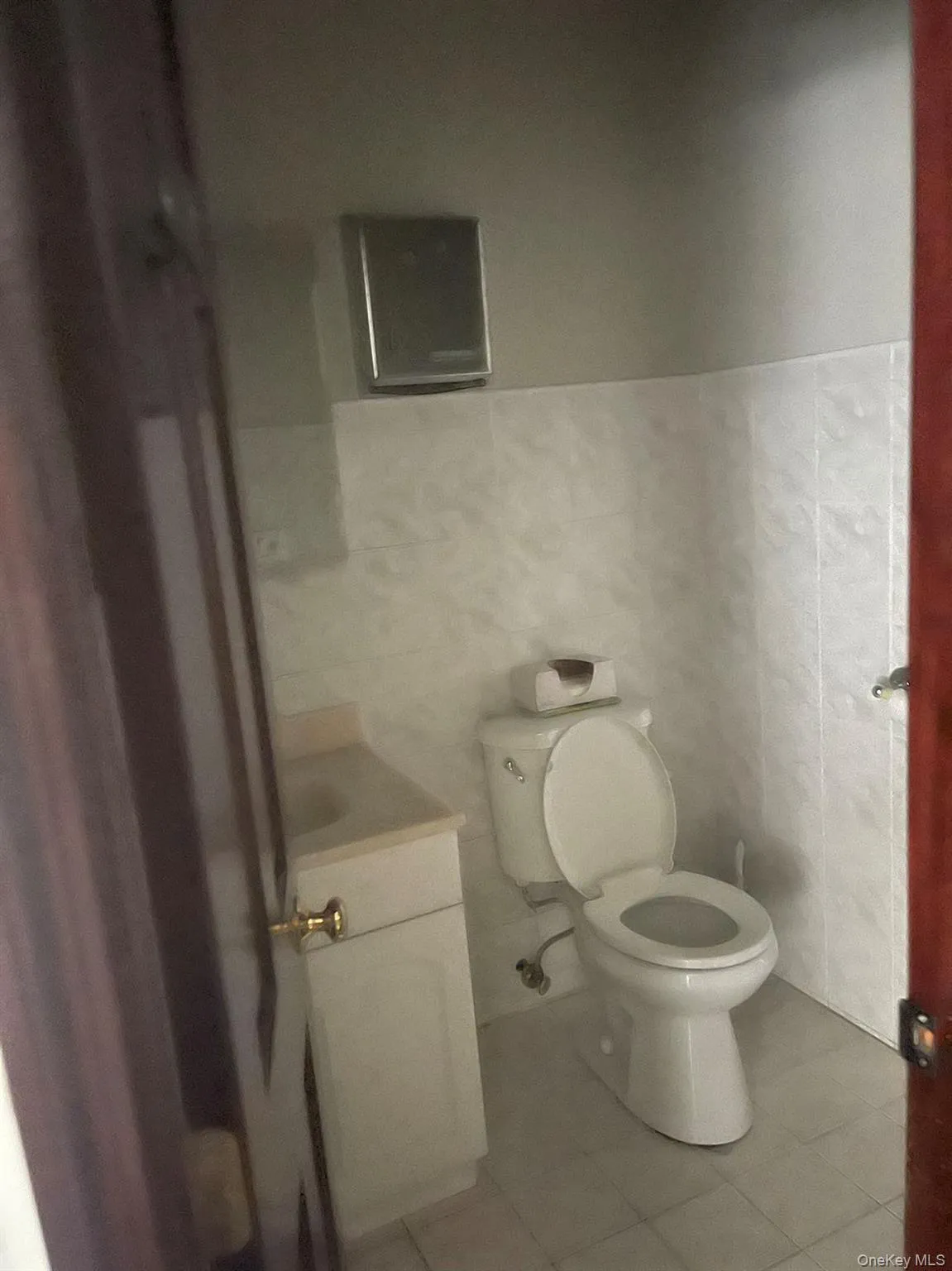 Half bathroom featuring vanity and light tile patterned floors Half bathroom featuring vanity and light tile patterned floors