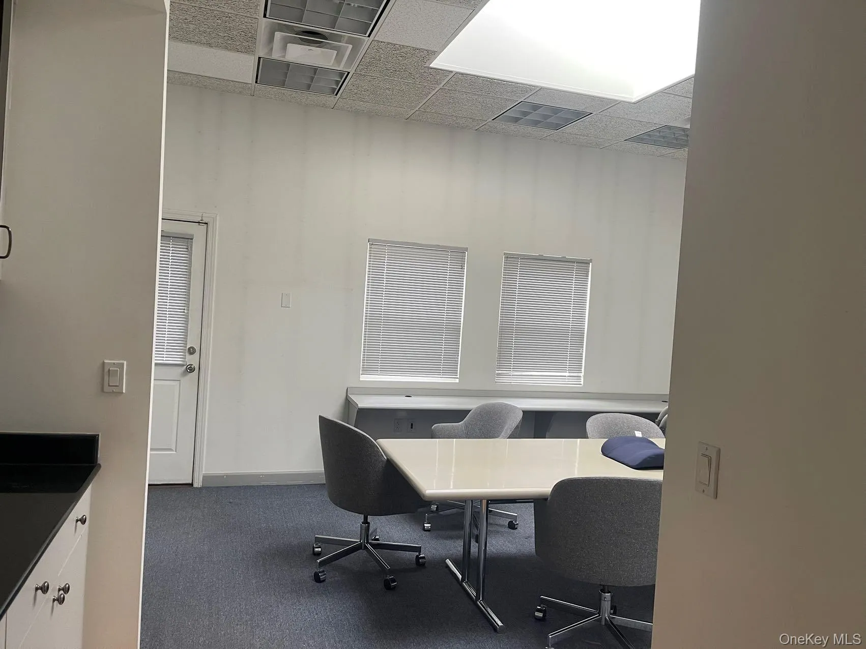 Office area with a paneled ceiling Office area with a paneled ceiling