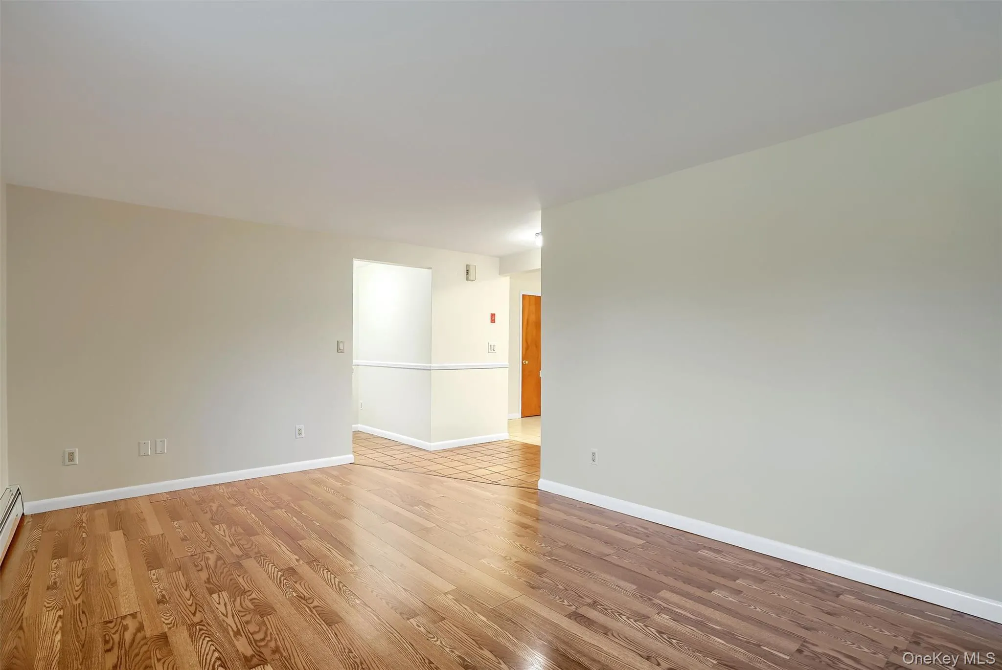 Unfurnished room with light wood-style flooring and baseboards Unfurnished room with light wood-style flooring and baseboards