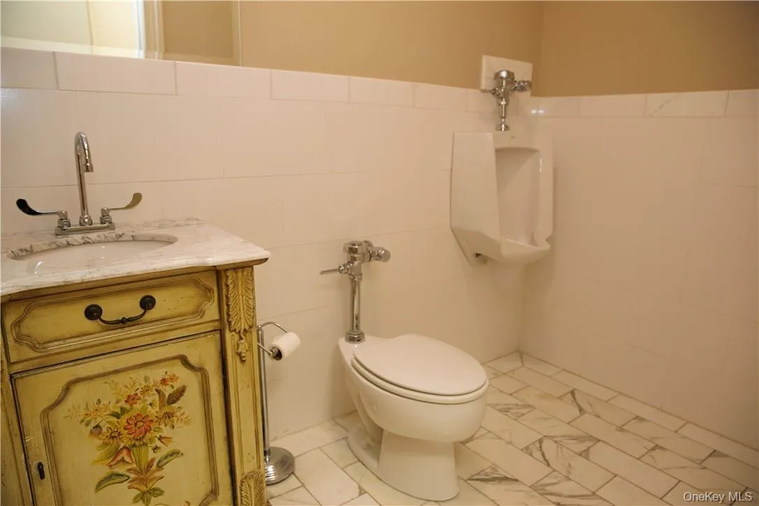 Stylish bathroom with half-wall subway tiling. Stylish bathroom with half-wall subway tiling.