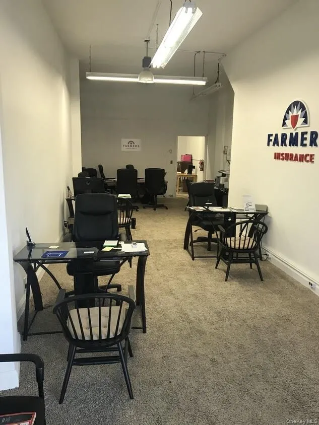 Dining space featuring a high ceiling and light carpet Dining space featuring a high ceiling and light carpet