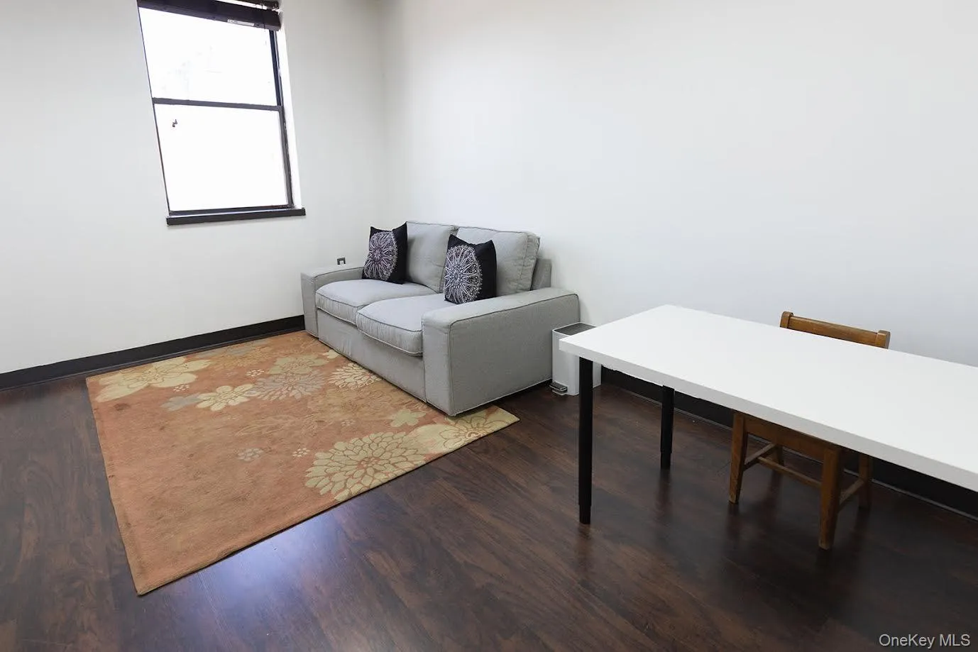 Office space featuring dark wood-style flooring and baseboards Office space featuring dark wood-style flooring and baseboards