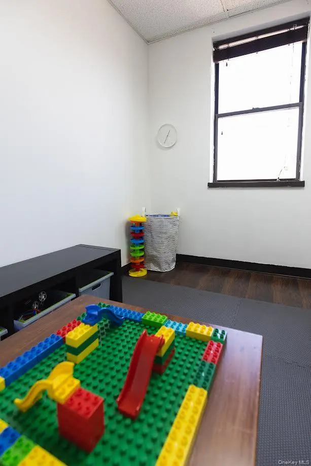 Room with dark wood-type flooring and baseboards Room with dark wood-type flooring and baseboards