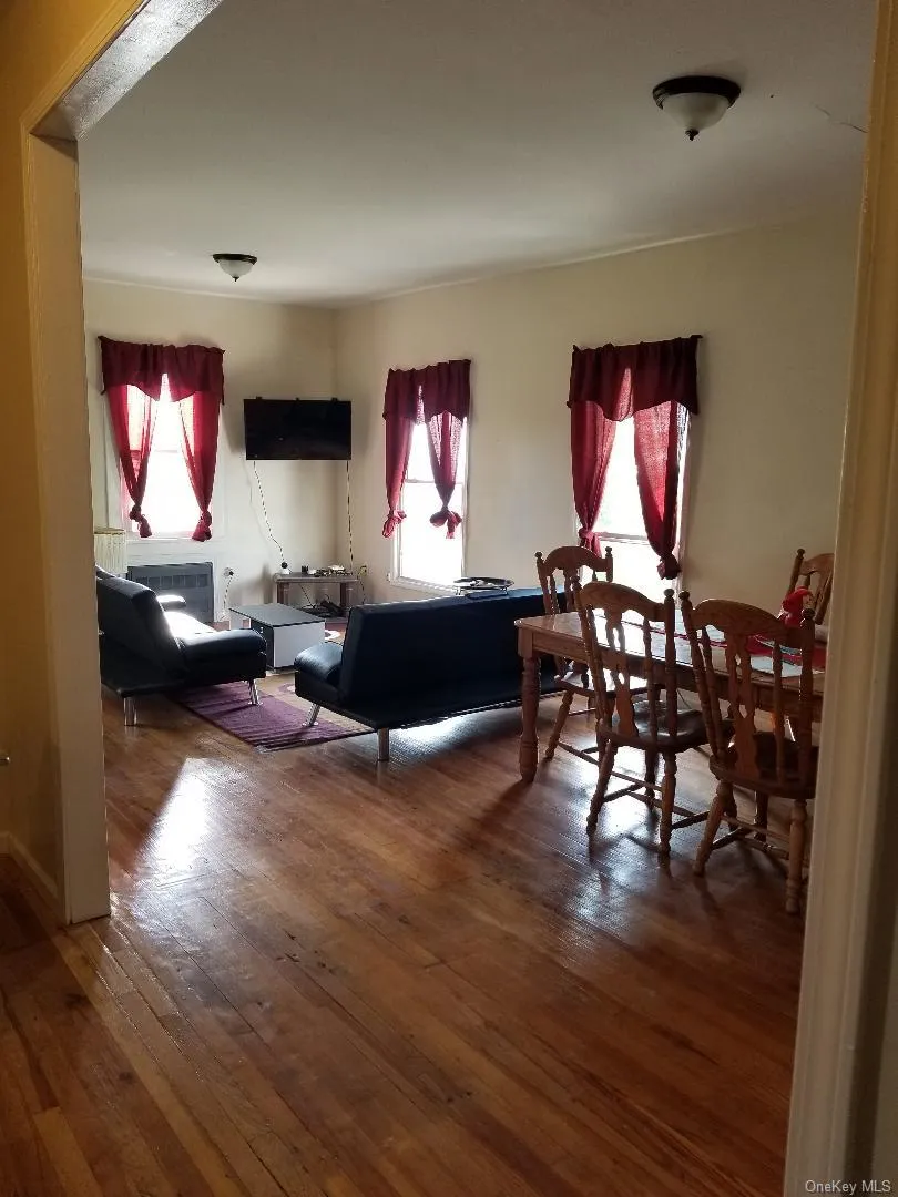 Living room featuring dark wood-style flooring Living room featuring dark wood-style flooring