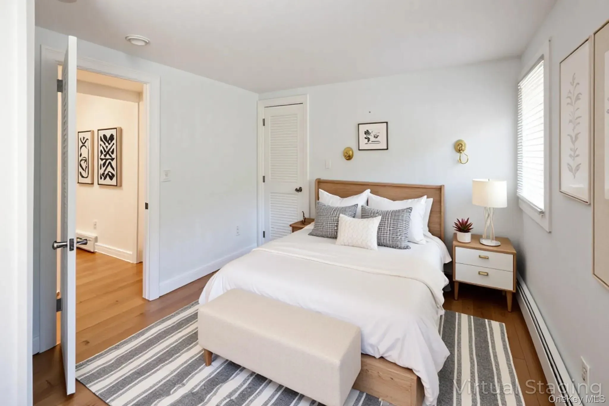 Virtually Staged Bedroom featuring a baseboard heating unit, wood finished floors, a closet, and baseboard heating Virtually Staged Bedroom featuring a baseboard heating unit, wood finished floors, a closet, and baseboard heating