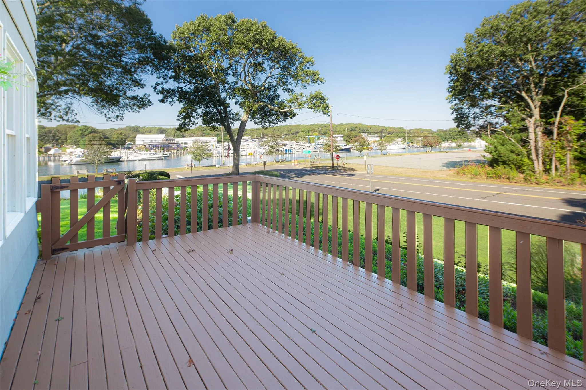 Deck featuring a yard and a water view Deck featuring a yard and a water view