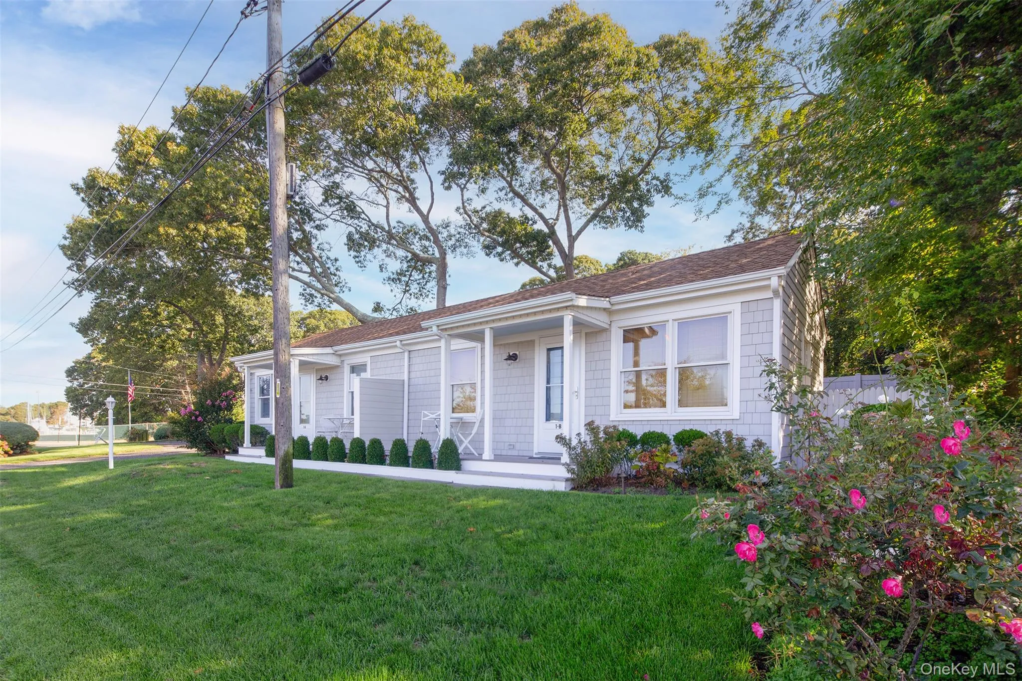 Bungalow-style home featuring covered porch and a shingled roof Bungalow-style home featuring covered porch and a shingled roof