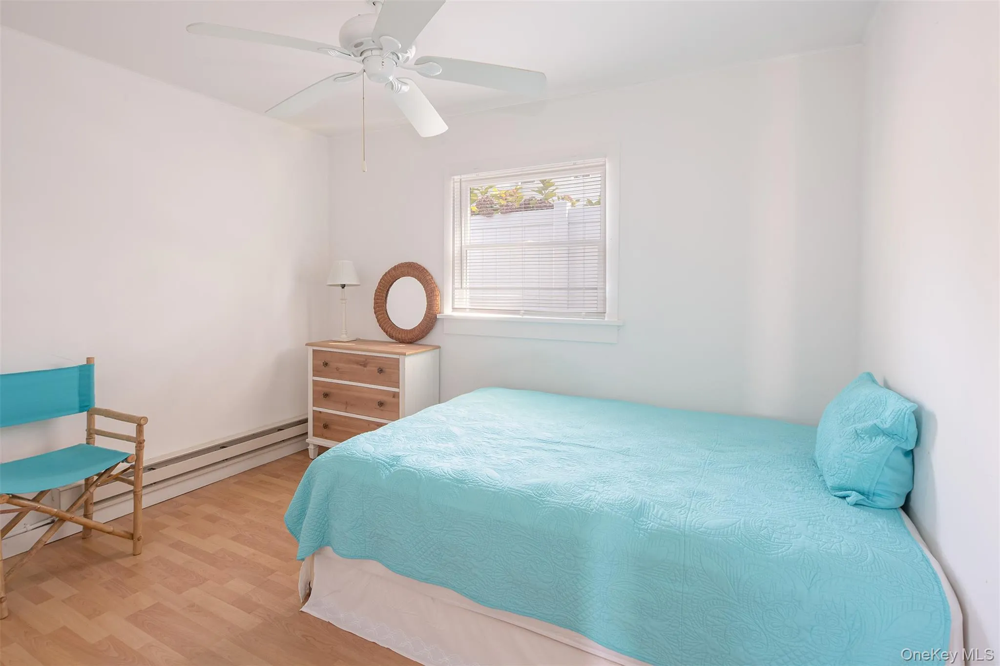 Bedroom featuring wood finished floors and a ceiling fan Bedroom featuring wood finished floors and a ceiling fan