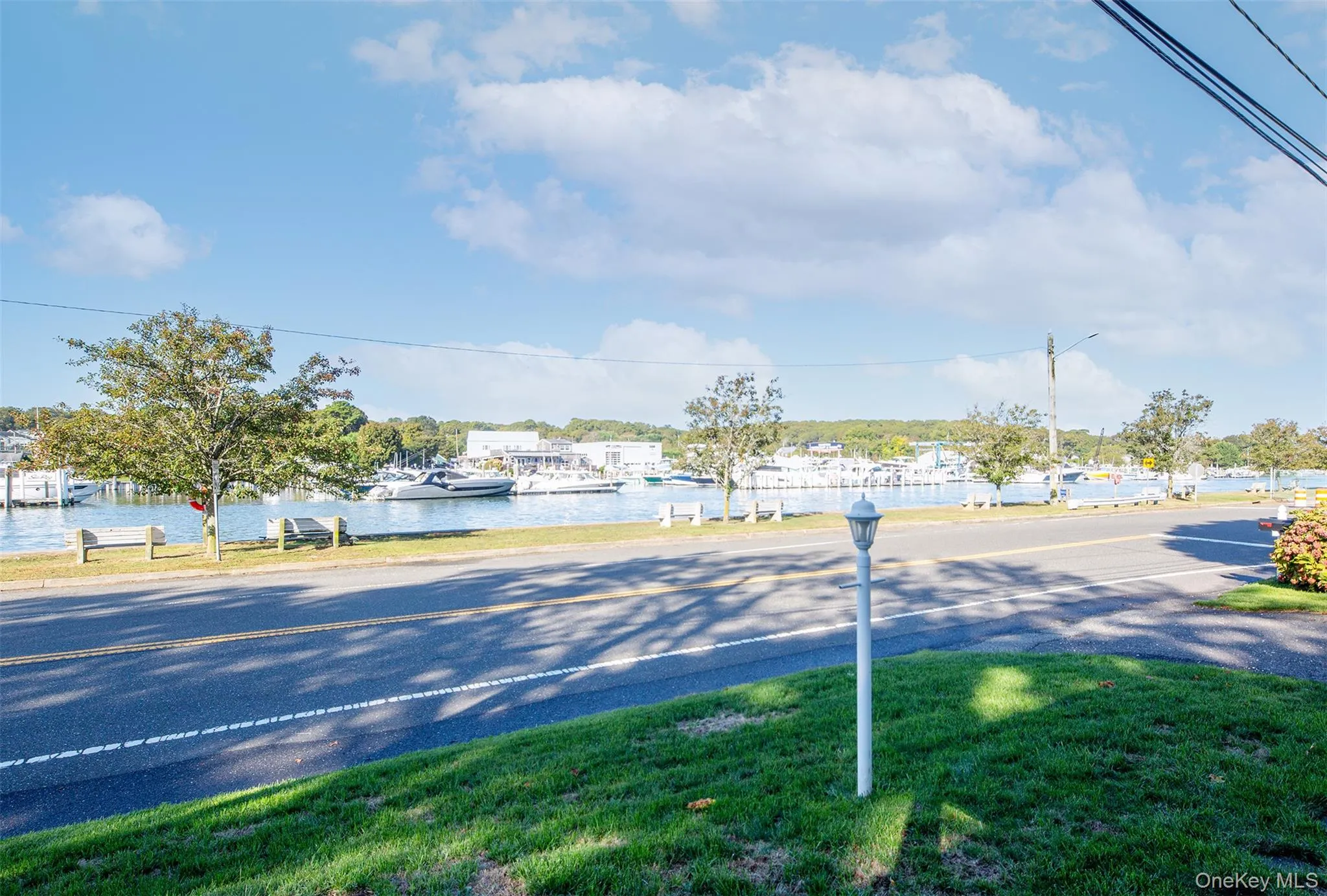 View of asphalt street with street lighting and a water view View of asphalt street with street lighting and a water view