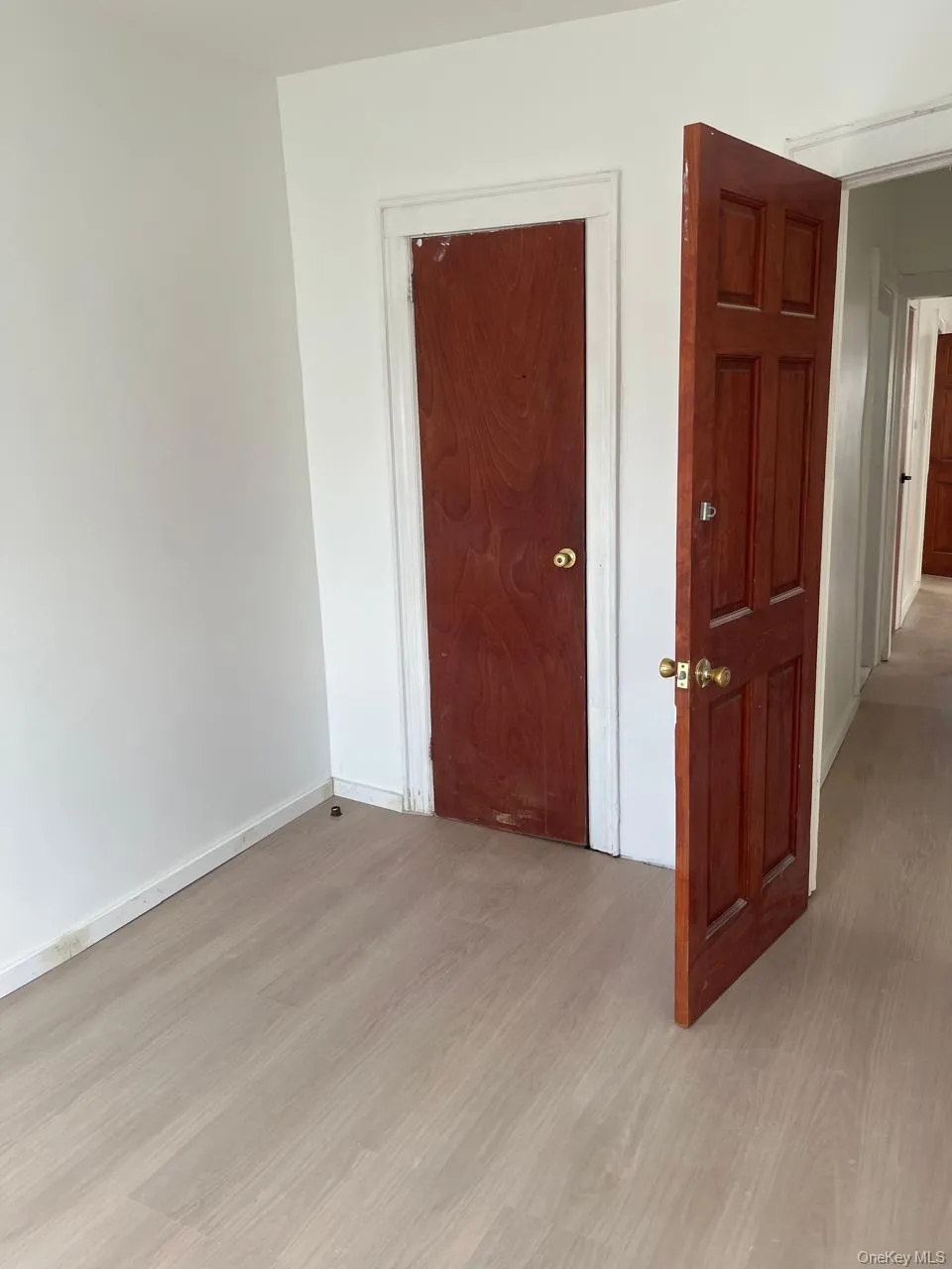 Unfurnished bedroom with light wood finished floors and baseboards Unfurnished bedroom with light wood finished floors and baseboards