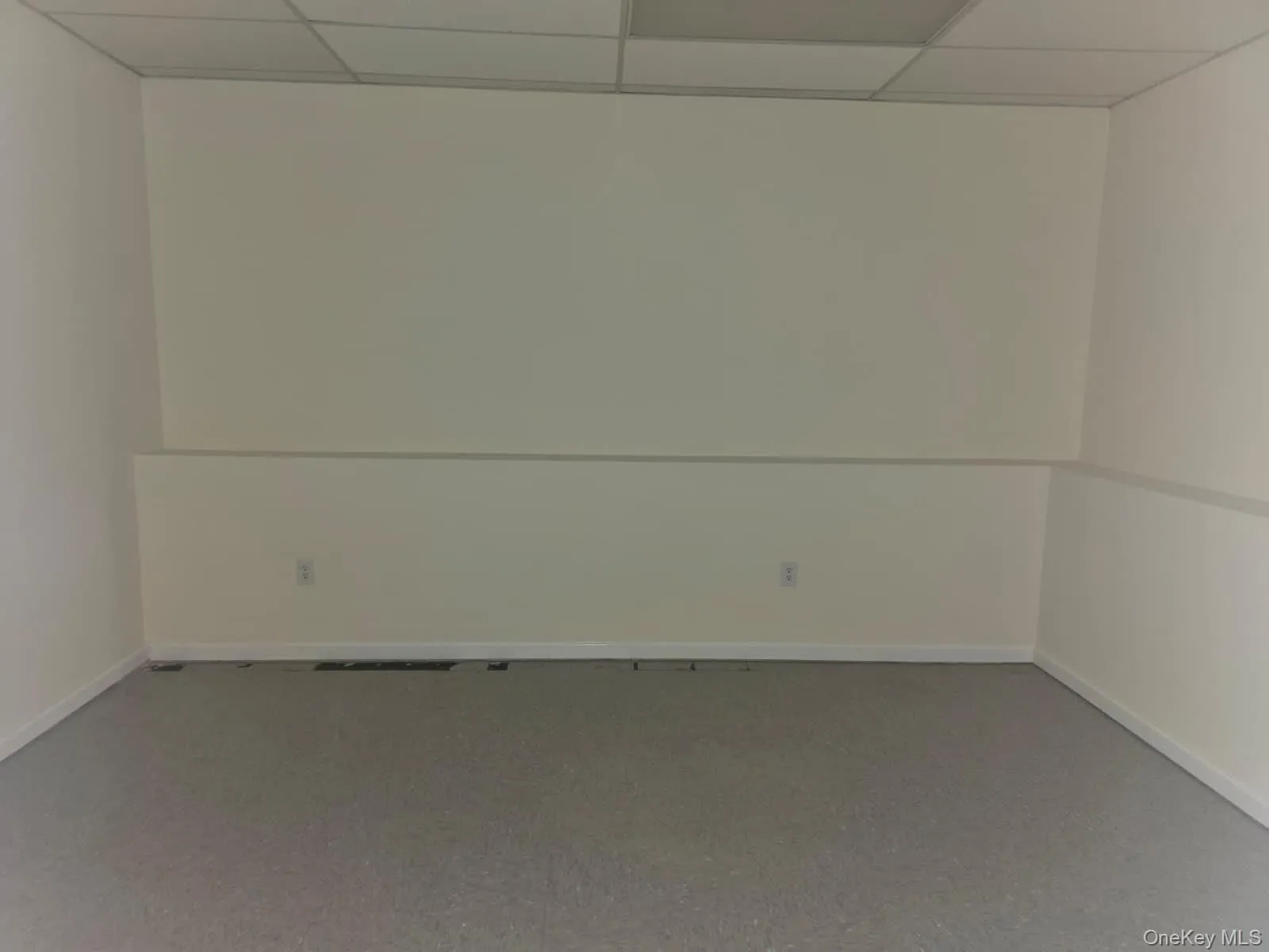 Empty room featuring a paneled ceiling Empty room featuring a paneled ceiling