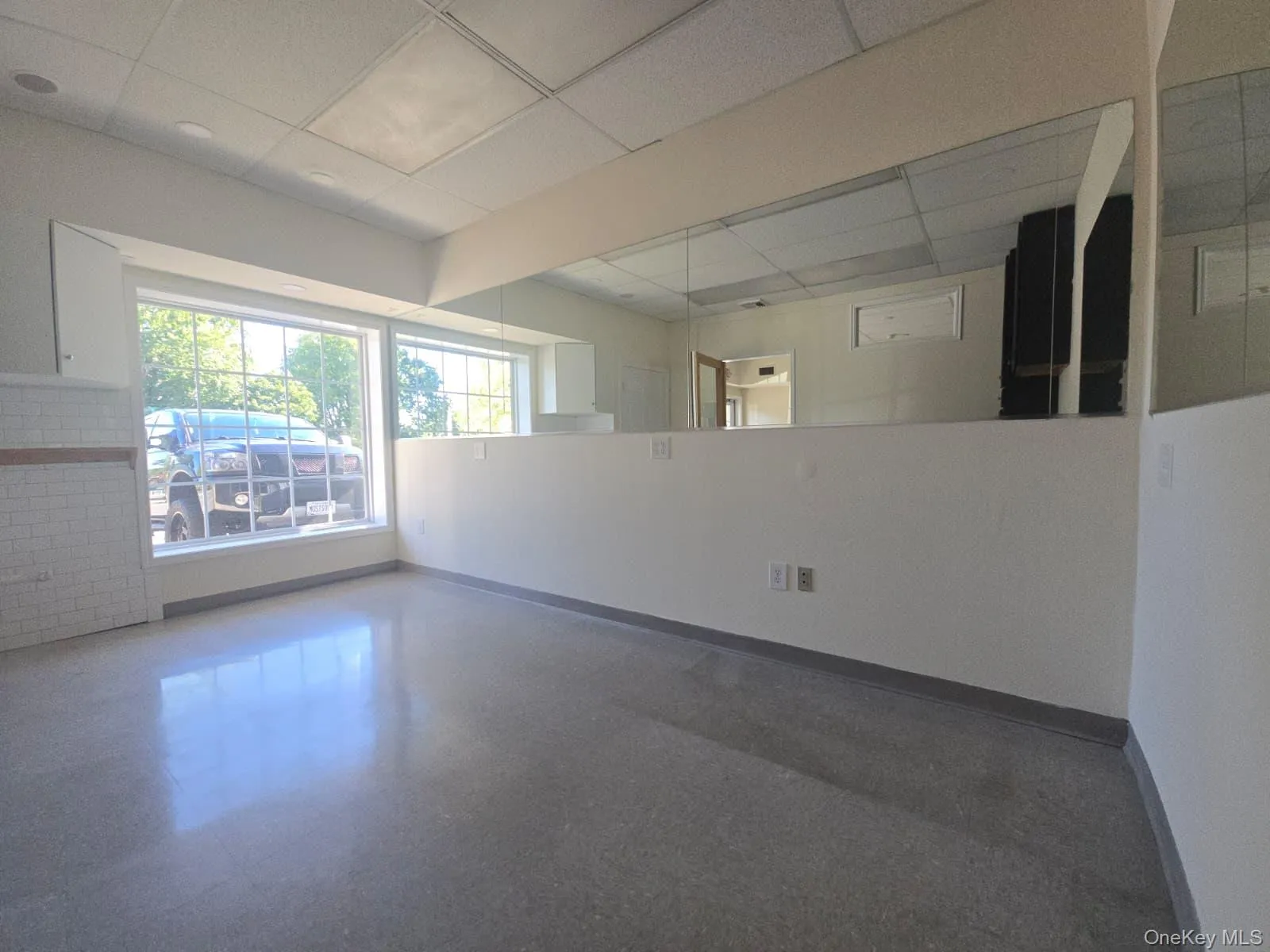 Spare room featuring a paneled ceiling and baseboards Spare room featuring a paneled ceiling and baseboards