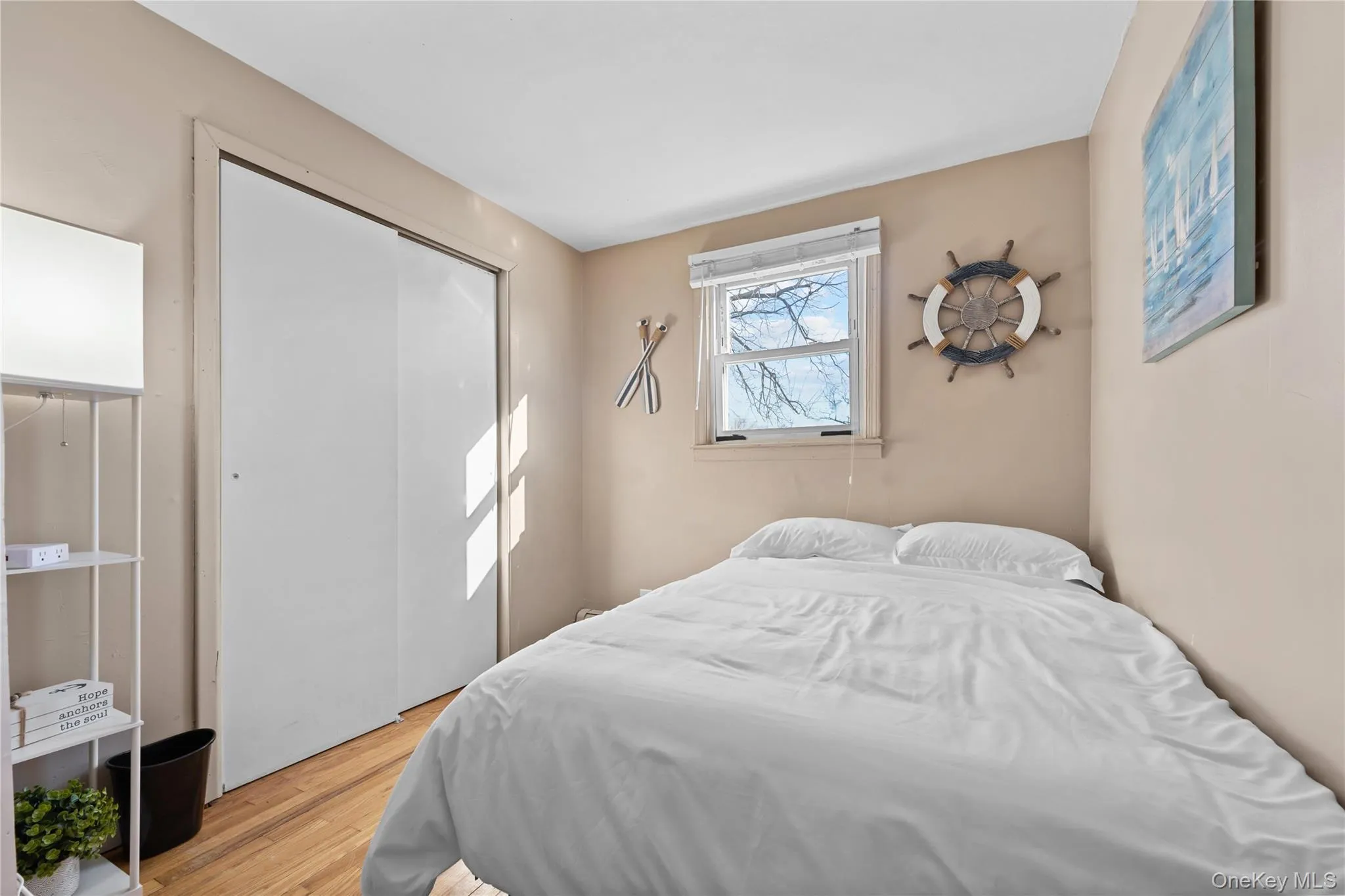 Bedroom featuring wood finished floors and a closet Bedroom featuring wood finished floors and a closet