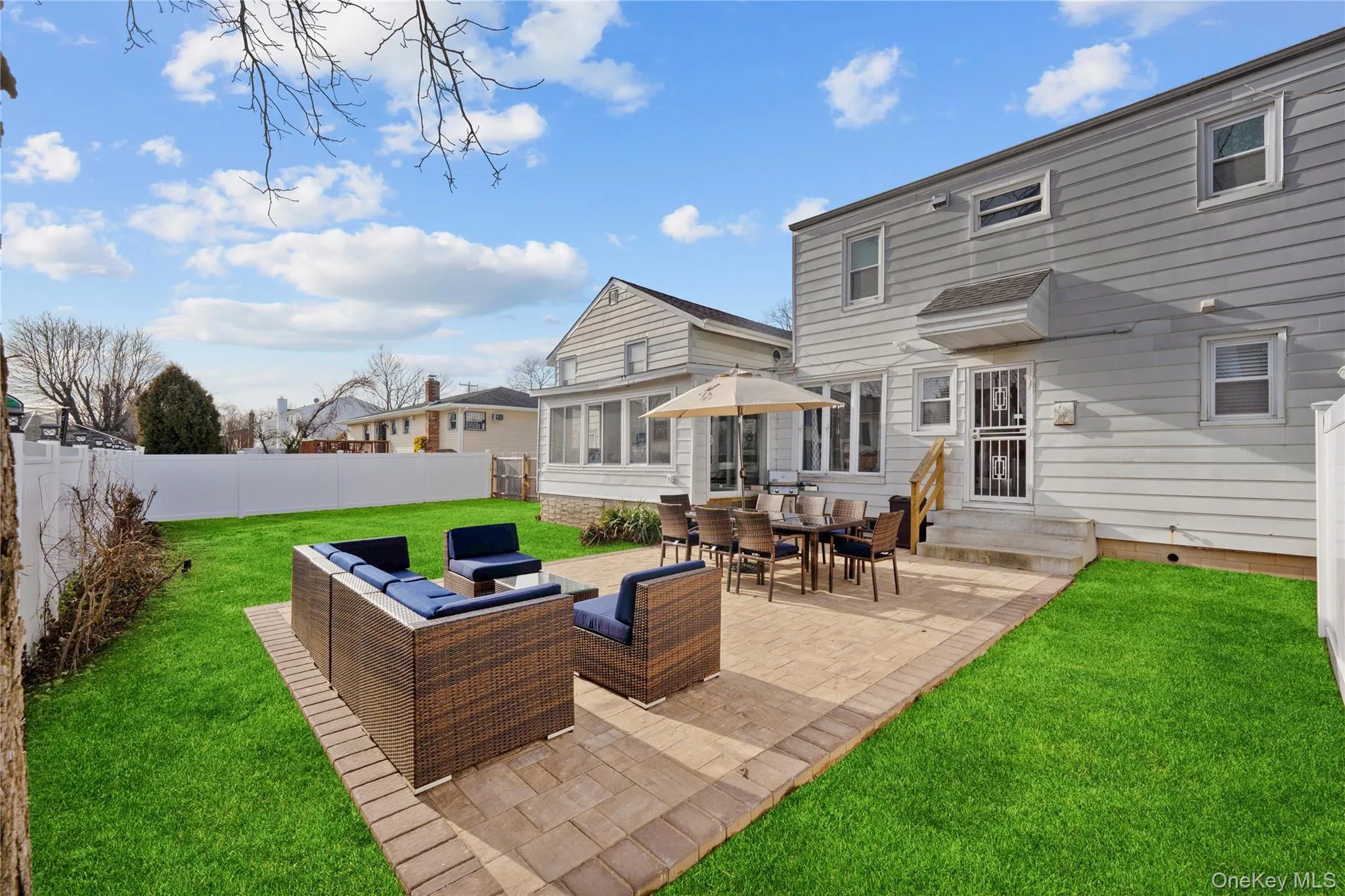 Rear view of house featuring an outdoor hangout area, a patio, entry steps, a sunroom, and a fenced backyard Rear view of house featuring an outdoor hangout area, a patio, entry steps, a sunroom, and a fenced backyard