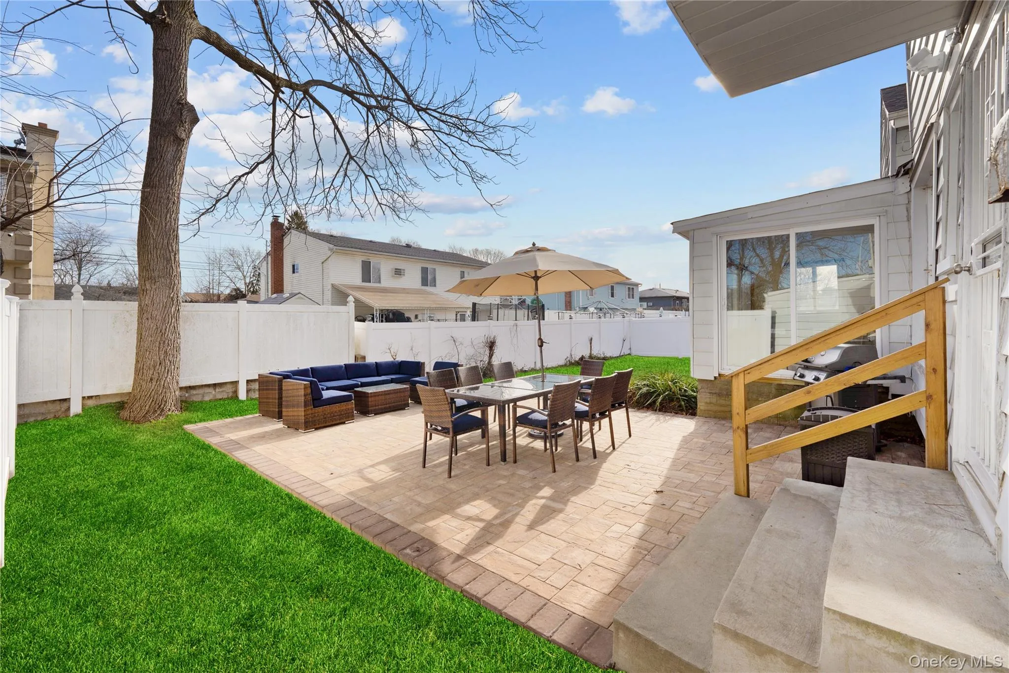Fenced backyard with an outdoor hangout area, a patio area, and outdoor dining space Fenced backyard with an outdoor hangout area, a patio area, and outdoor dining space