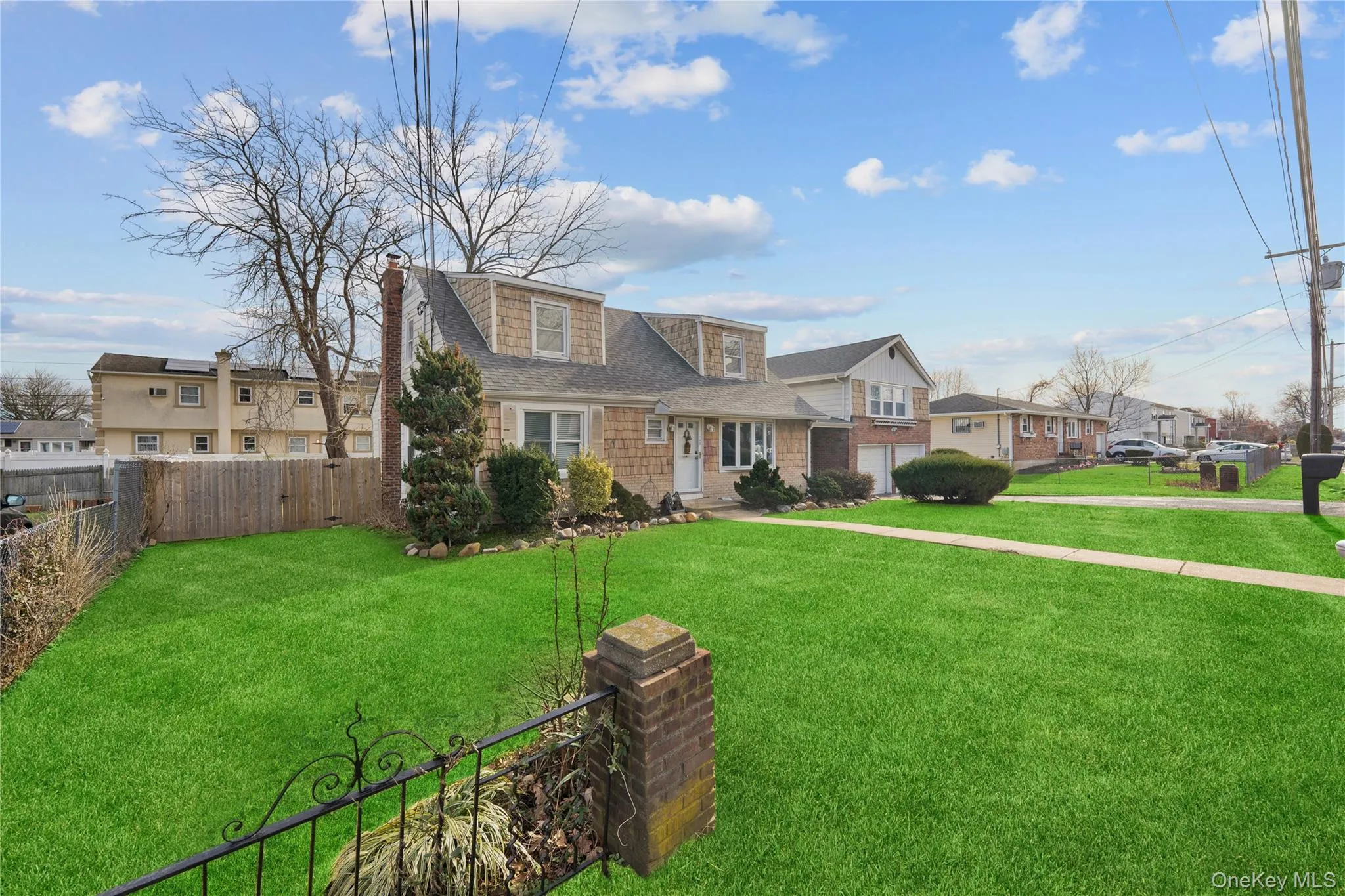 View of front of house with a chimney, a residential view, and a shingled roof View of front of house with a chimney, a residential view, and a shingled roof