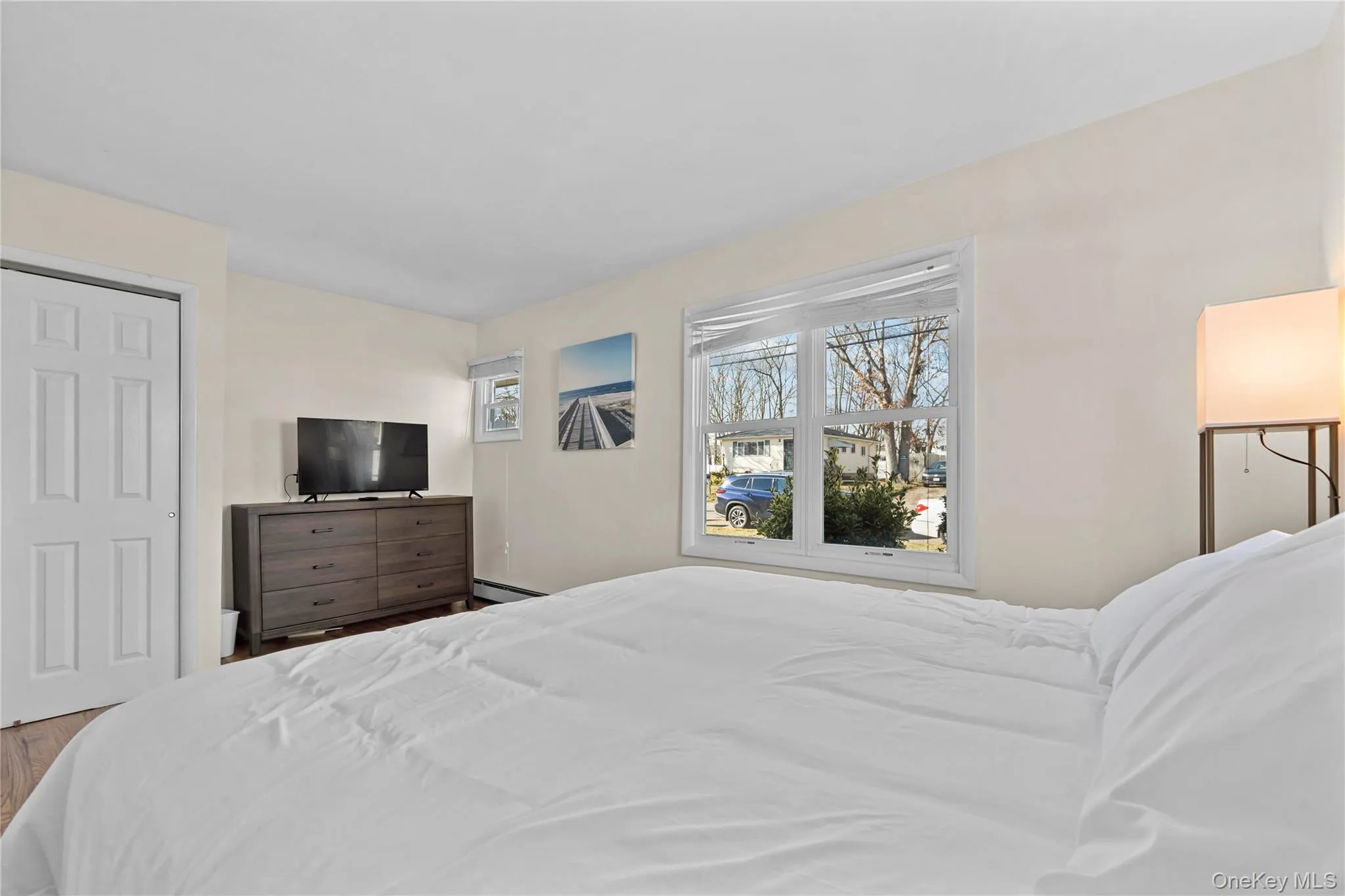 Bedroom featuring a closet and a baseboard radiator Bedroom featuring a closet and a baseboard radiator