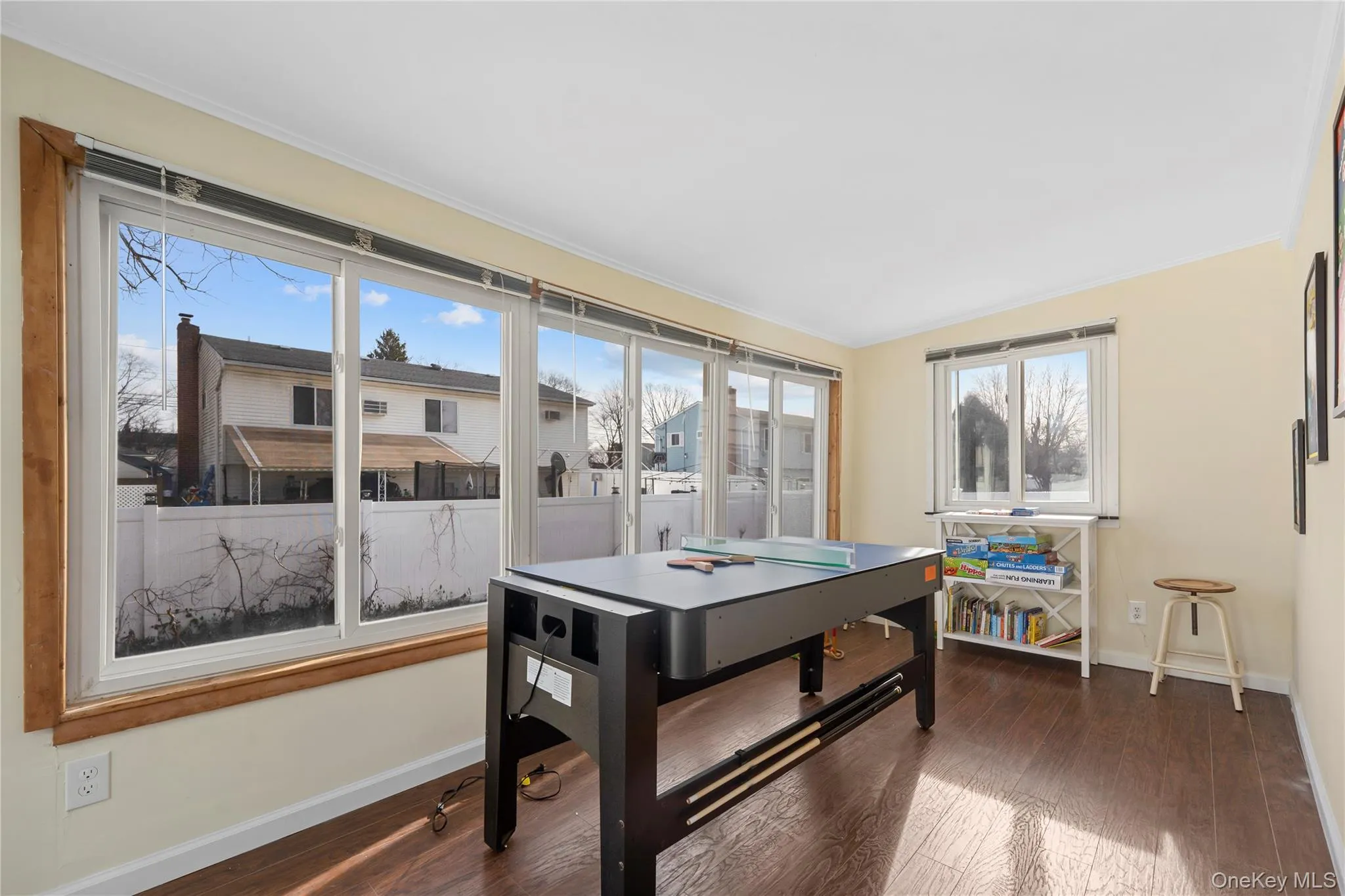 Dining room featuring dark wood finished floors and ornamental molding Dining room featuring dark wood finished floors and ornamental molding