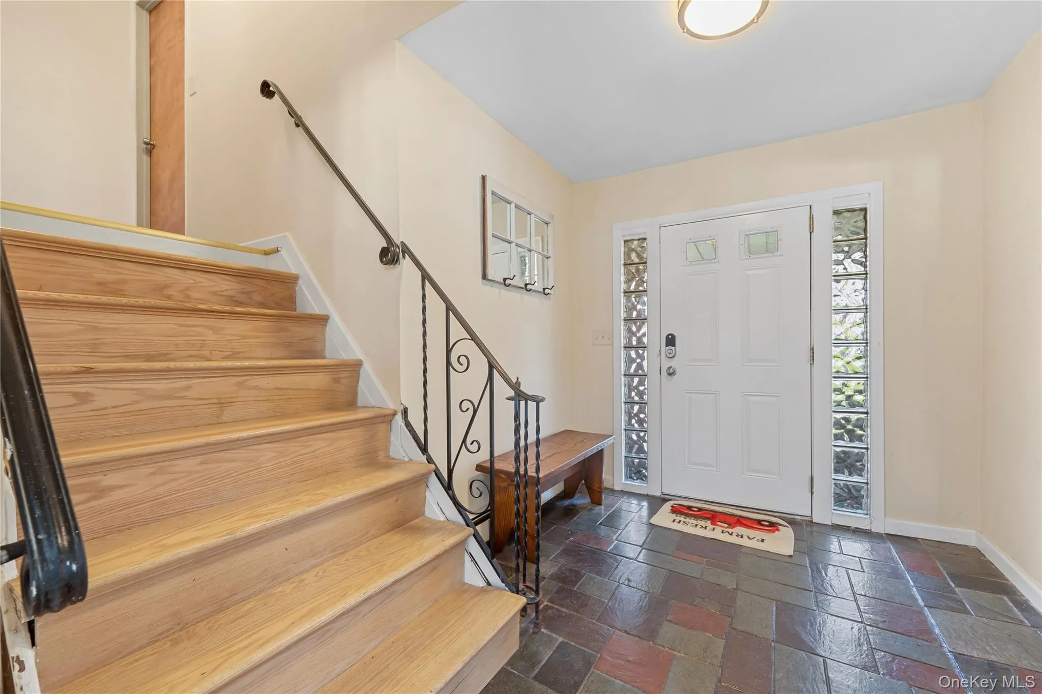 Entrance foyer with stairs and stone tile flooring Entrance foyer with stairs and stone tile flooring