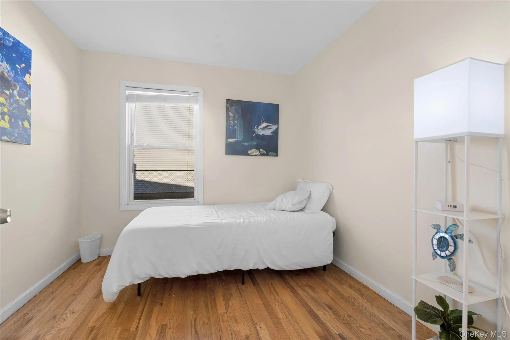 Bedroom with wood finished floors and baseboards Bedroom with wood finished floors and baseboards