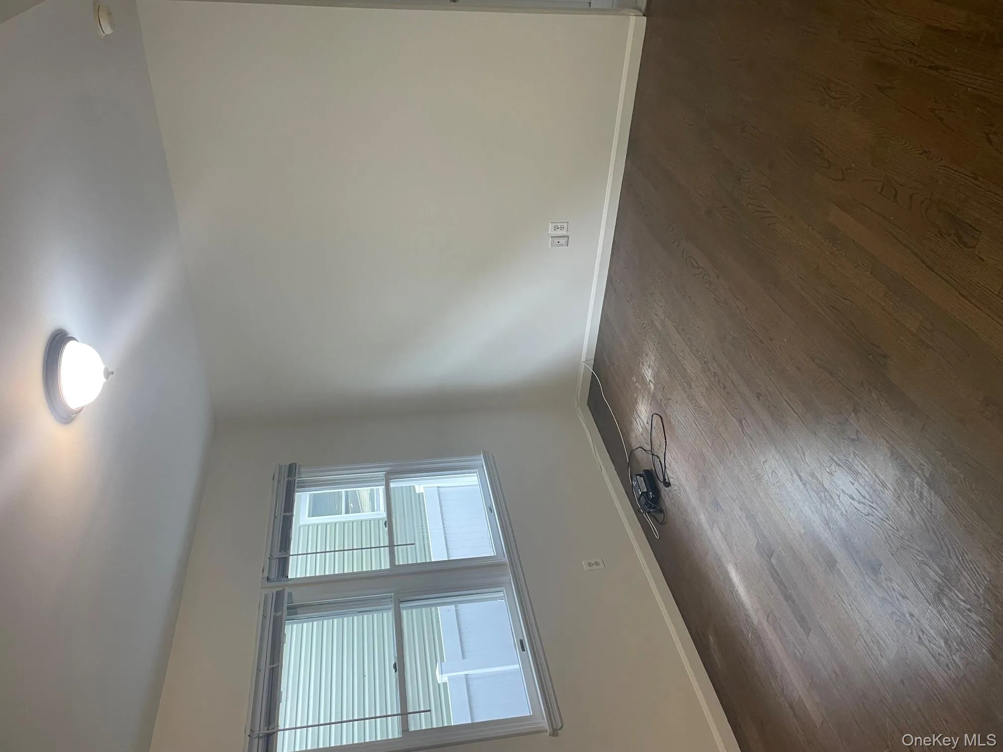 Empty room with baseboards and dark wood-style floors Empty room with baseboards and dark wood-style floors