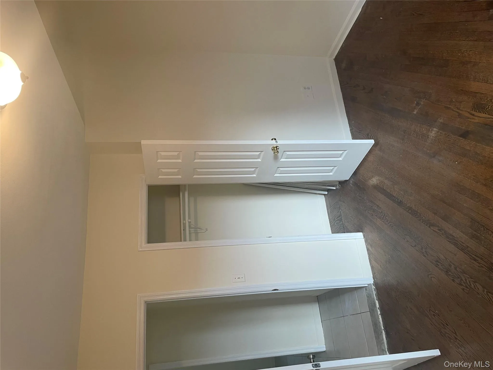 Unfurnished bedroom with dark wood-style flooring and a closet Unfurnished bedroom with dark wood-style flooring and a closet