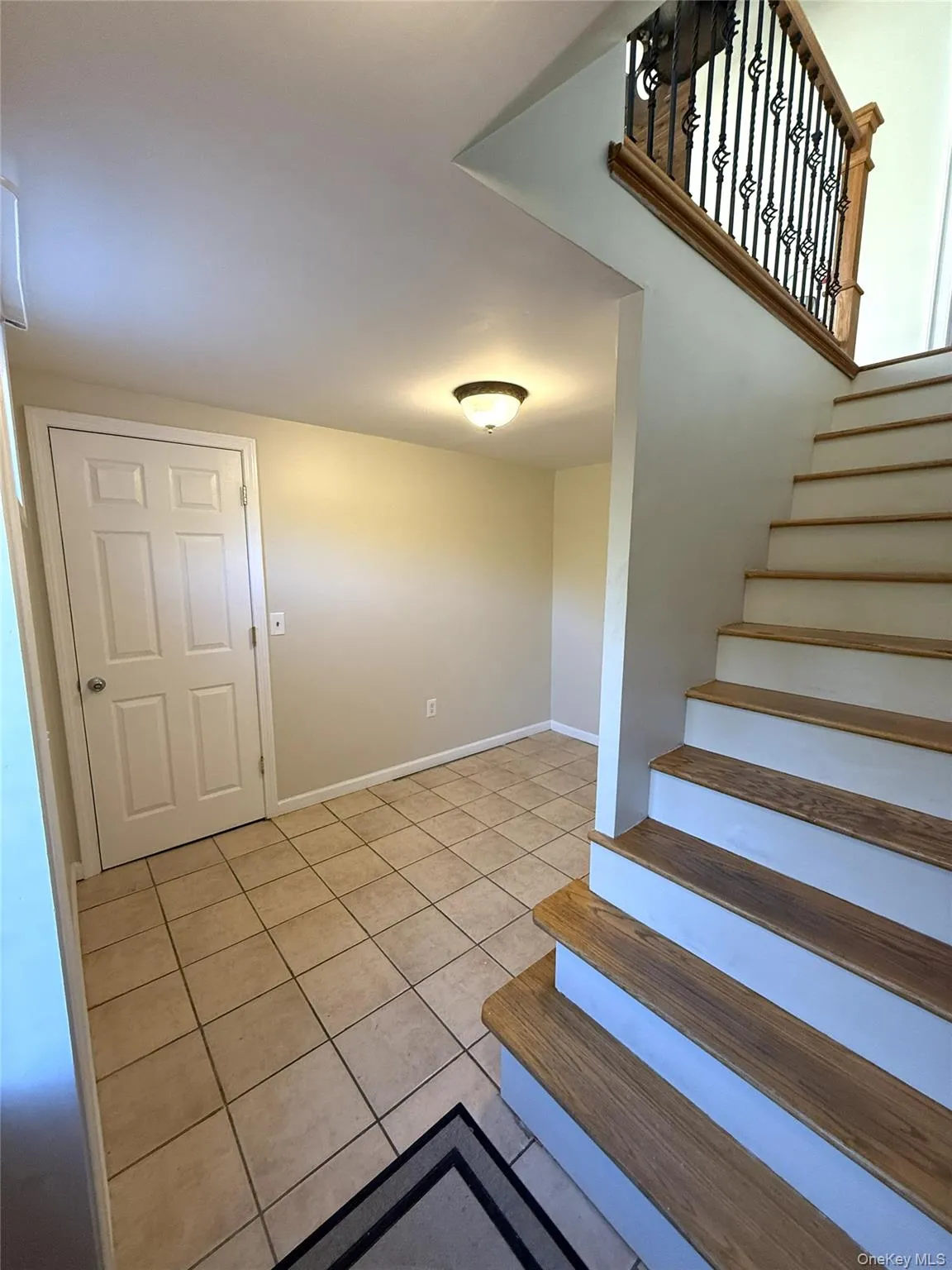 Staircase featuring tile patterned floors and baseboards Staircase featuring tile patterned floors and baseboards