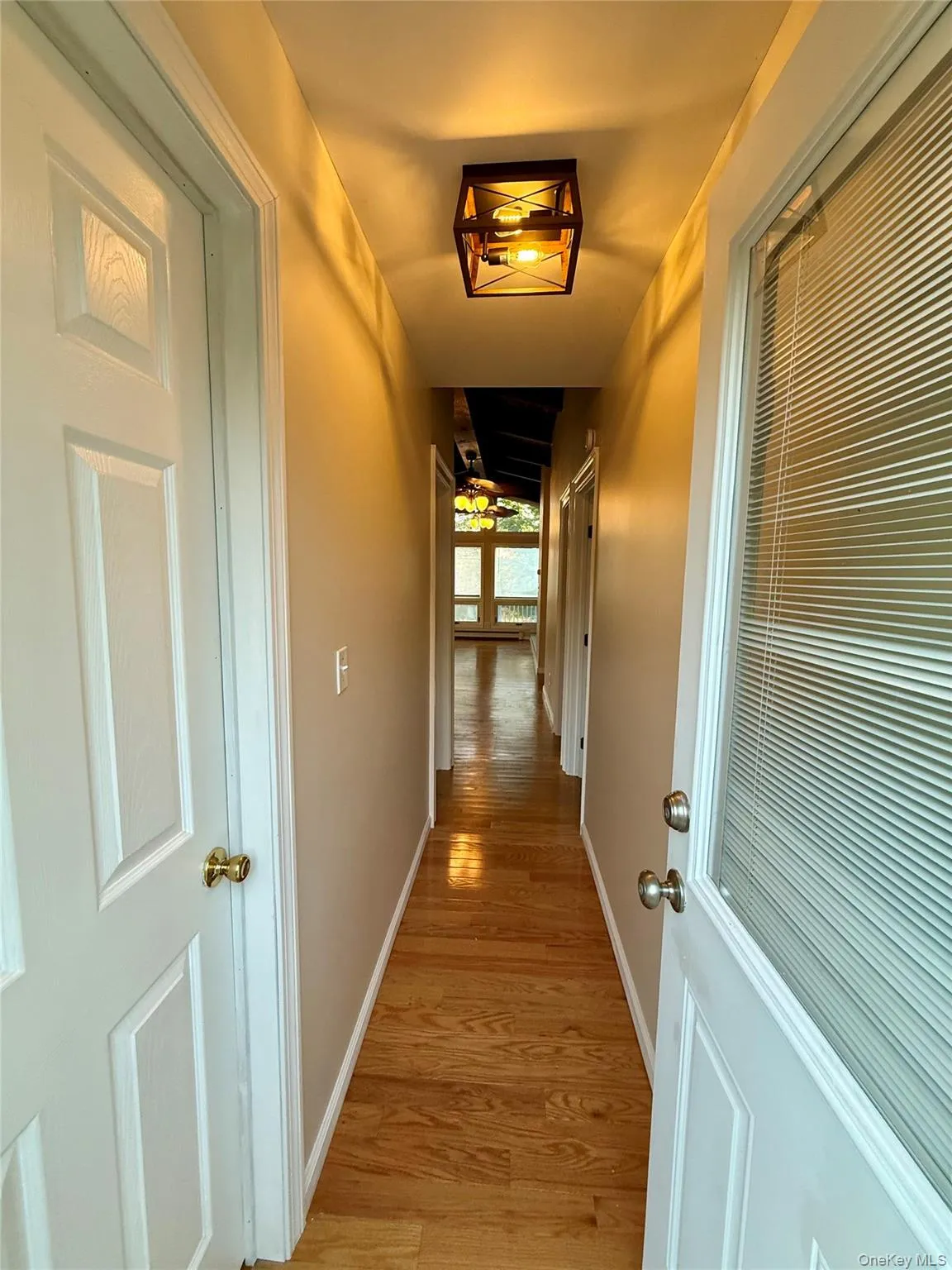 Hall with light wood finished floors and baseboards Hall with light wood finished floors and baseboards