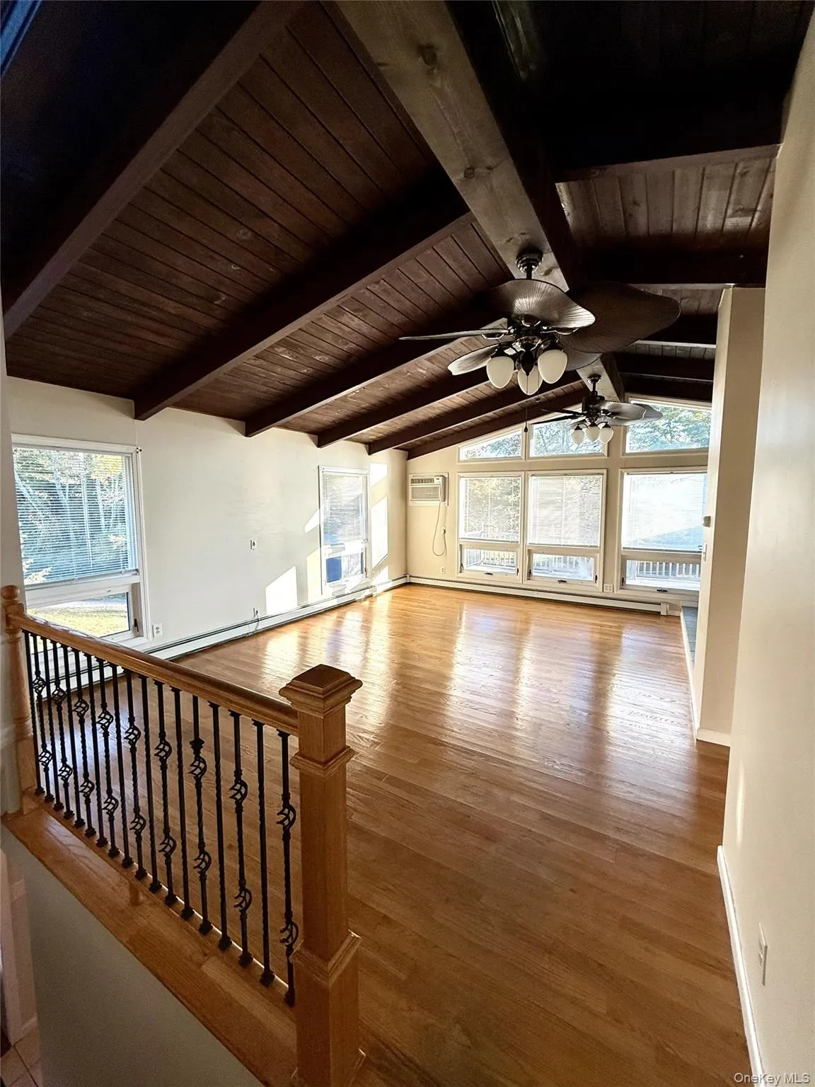 Bonus room featuring healthy amount of natural light, light wood-style flooring, wooden ceiling, and a ceiling fan Bonus room featuring healthy amount of natural light, light wood-style flooring, wooden ceiling, and a ceiling fan