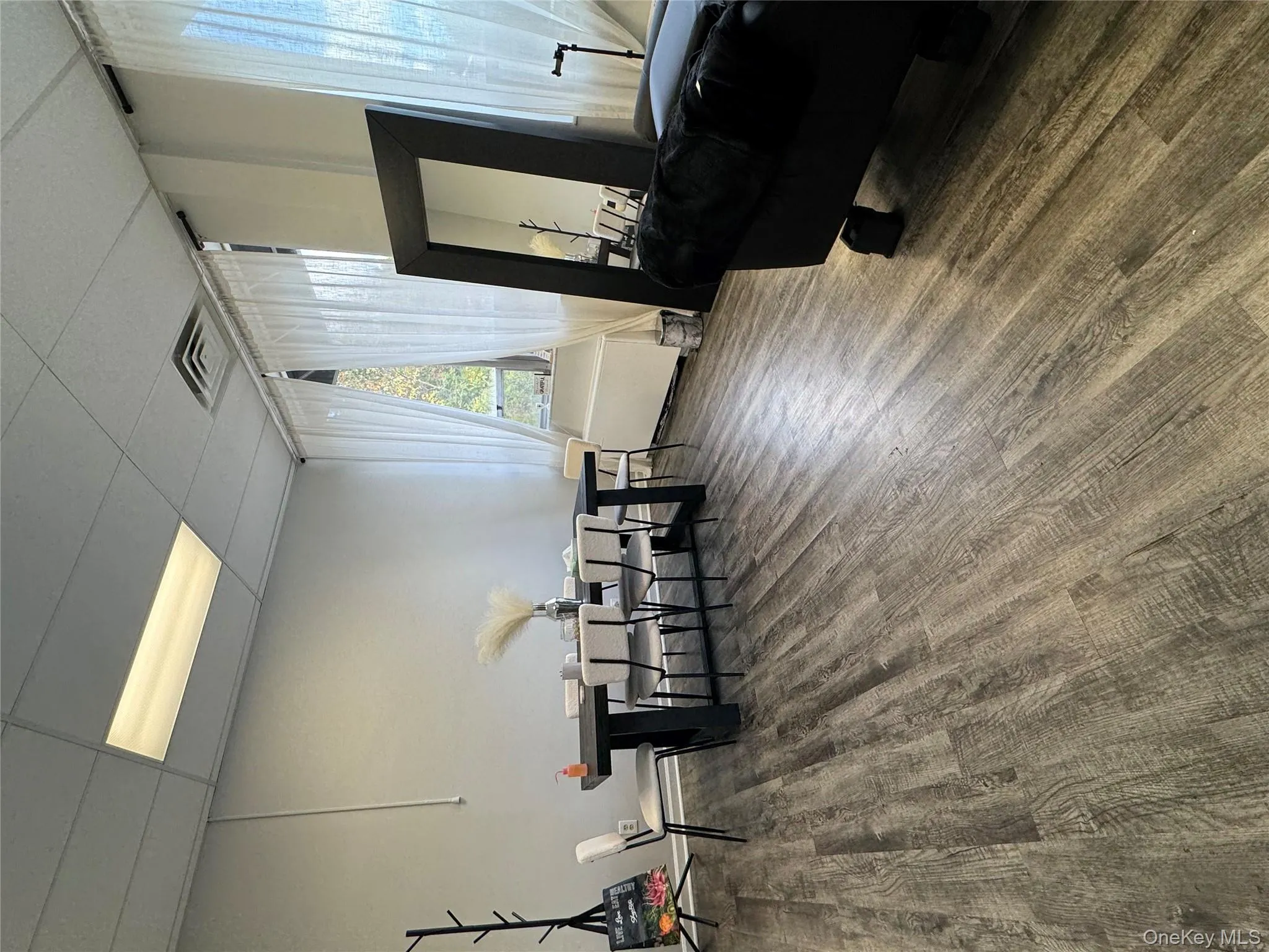 Dining room featuring a paneled ceiling and wood finished floors Dining room featuring a paneled ceiling and wood finished floors