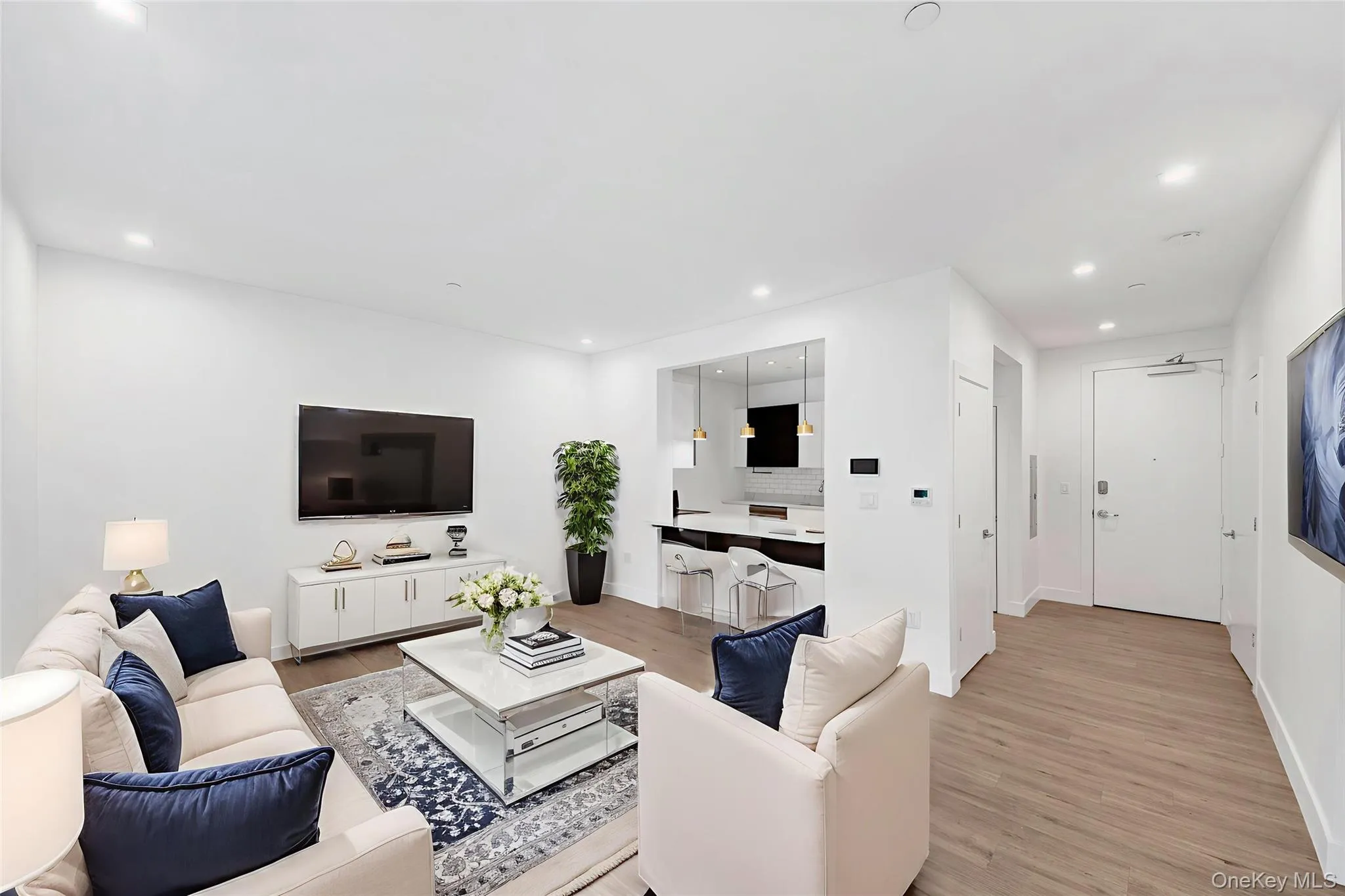 Living room featuring light wood-style flooring and recessed lighting Living room featuring light wood-style flooring and recessed lighting